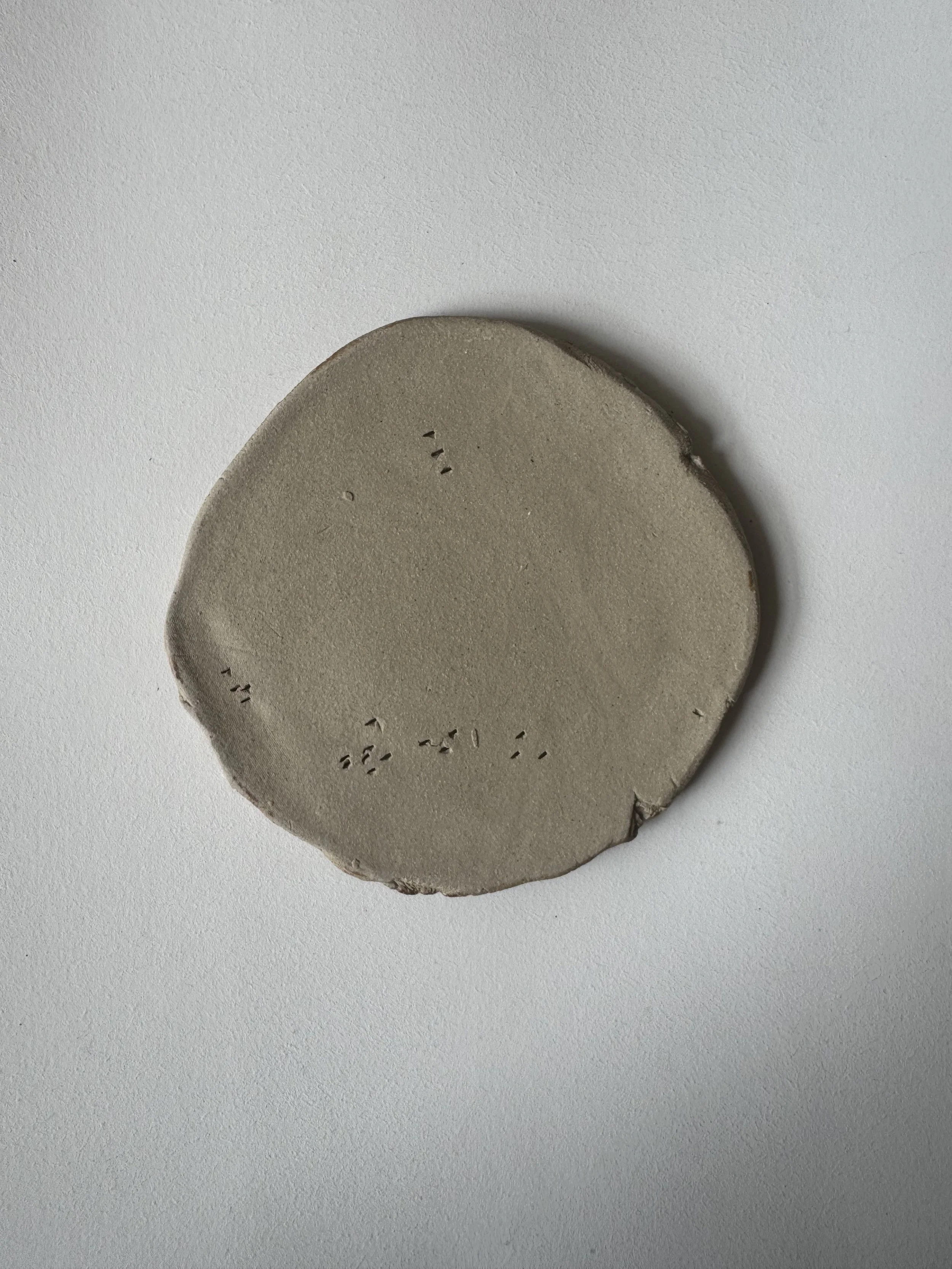 Ceramic face tile by Charlotte Salt