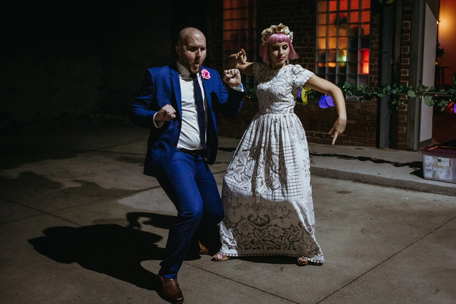 Bride with pink hair and her cool groom dancing at their night city Melbourne wedding