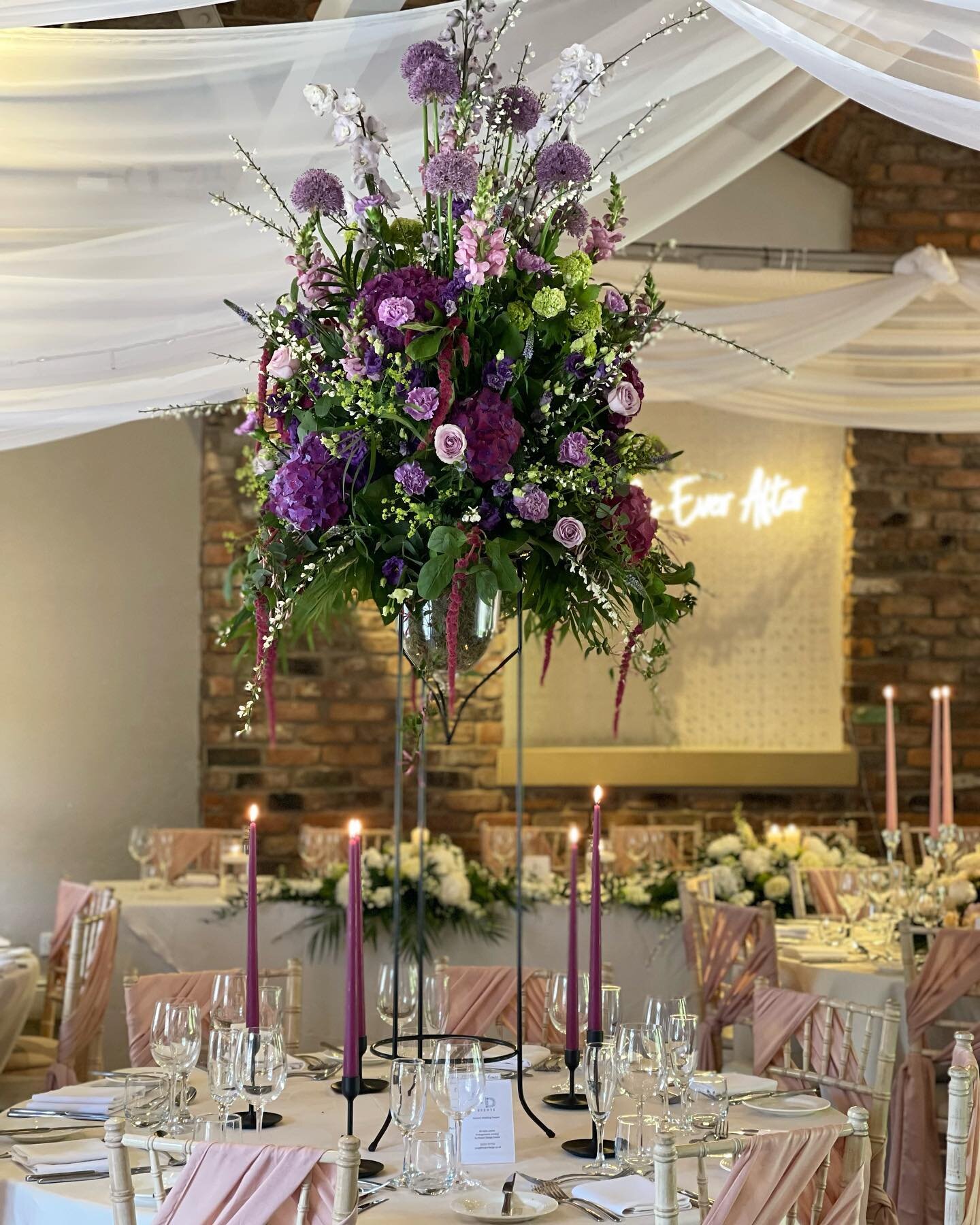 Love these sumptuous &lsquo;Summer Fruit Pudding&rsquo; shades in this gorgeous table centrepiece over at beautiful @bartlehallhotel we&rsquo;ve used a collection of Alliums, Delphiniums, Stocks, Hydrangeas, Roses, Amaranthus, Carnations, Veronica an