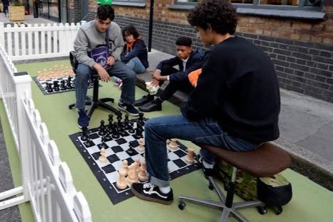 This parklet repurposes roadspace, to create an area for local young people to meet and play chess. 
