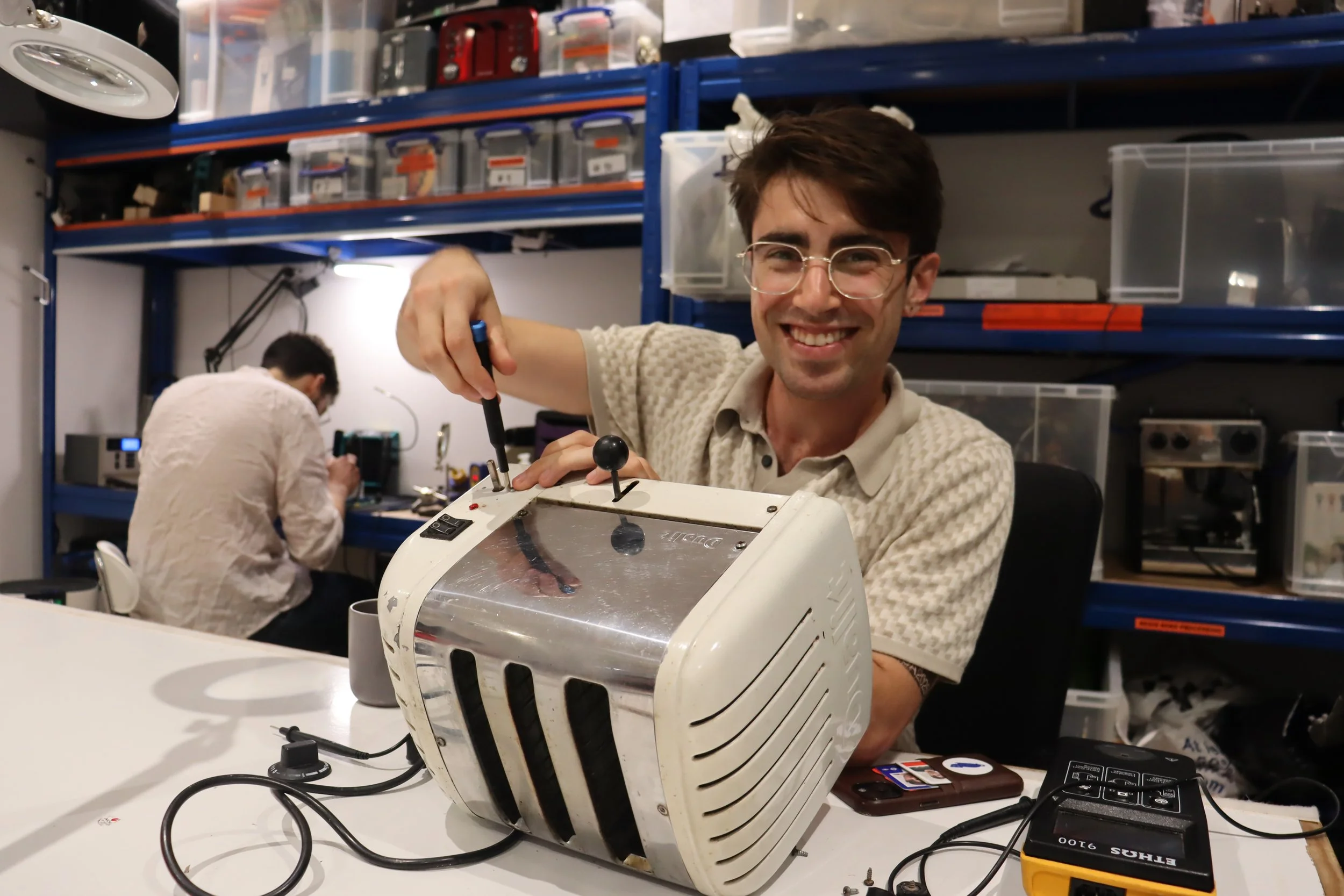 Volunteer Vincent fixing a toaster.