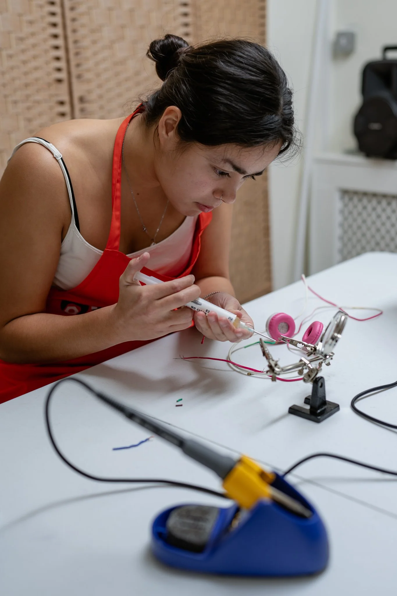 Workshop participant fixing headphones