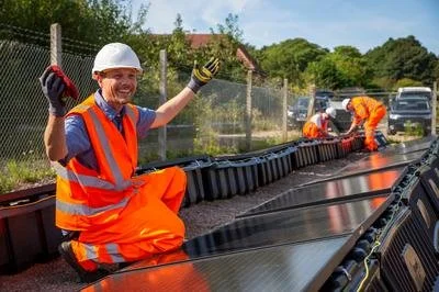 Man smiling by solar panels