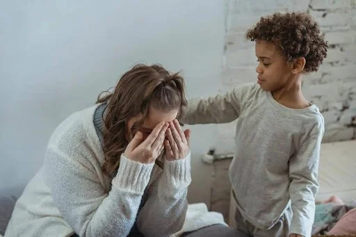Sad woman comforted by child