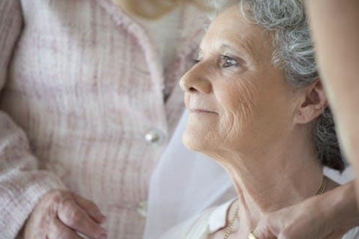 Older woman looking out window
