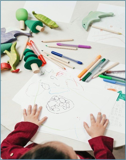 Kid sitting with craft supplies