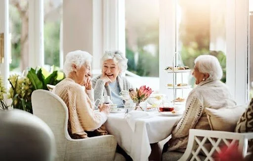Older women drinking coffee together