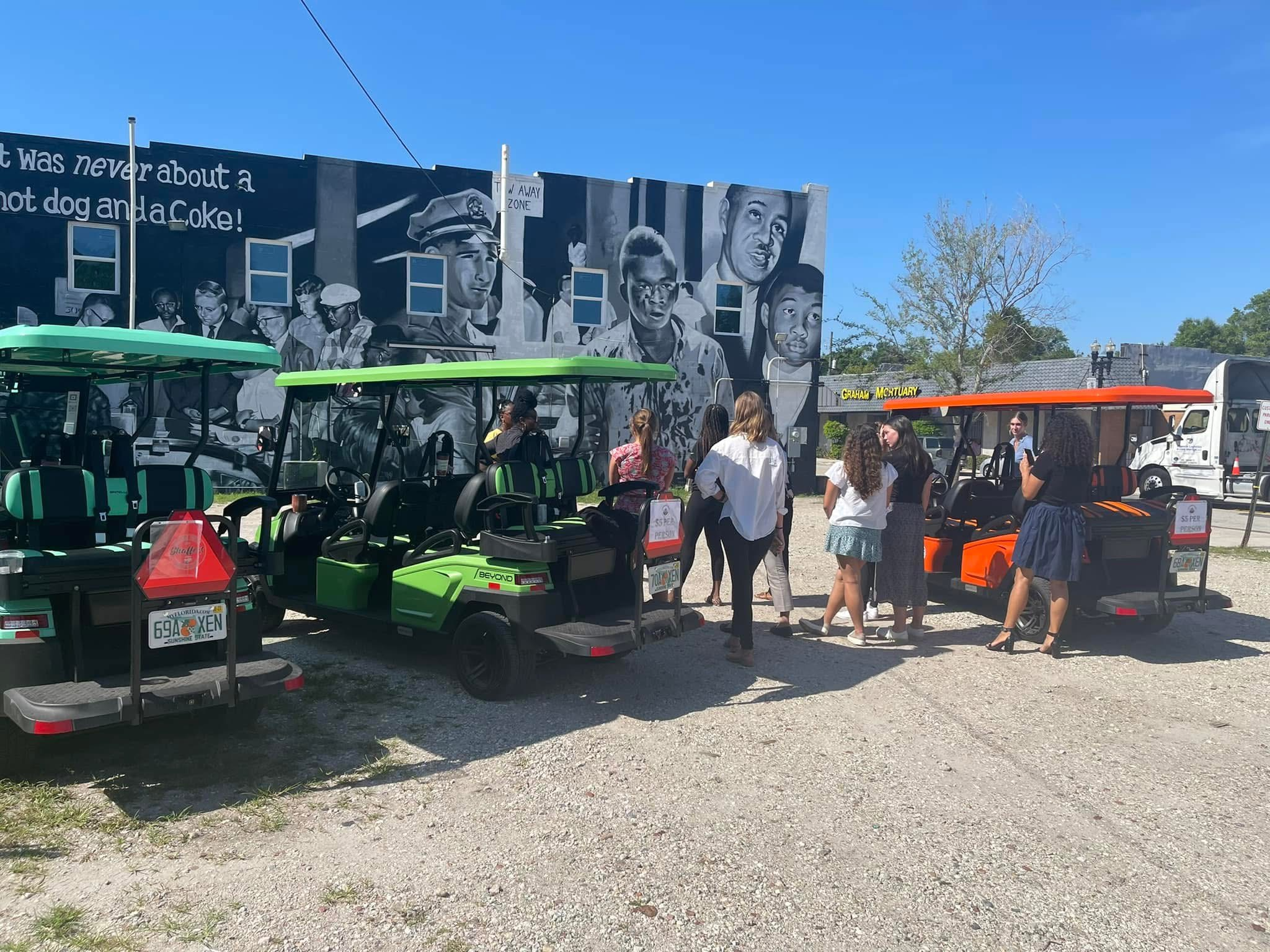 JAxi tour in front of Ax Handle mural.png