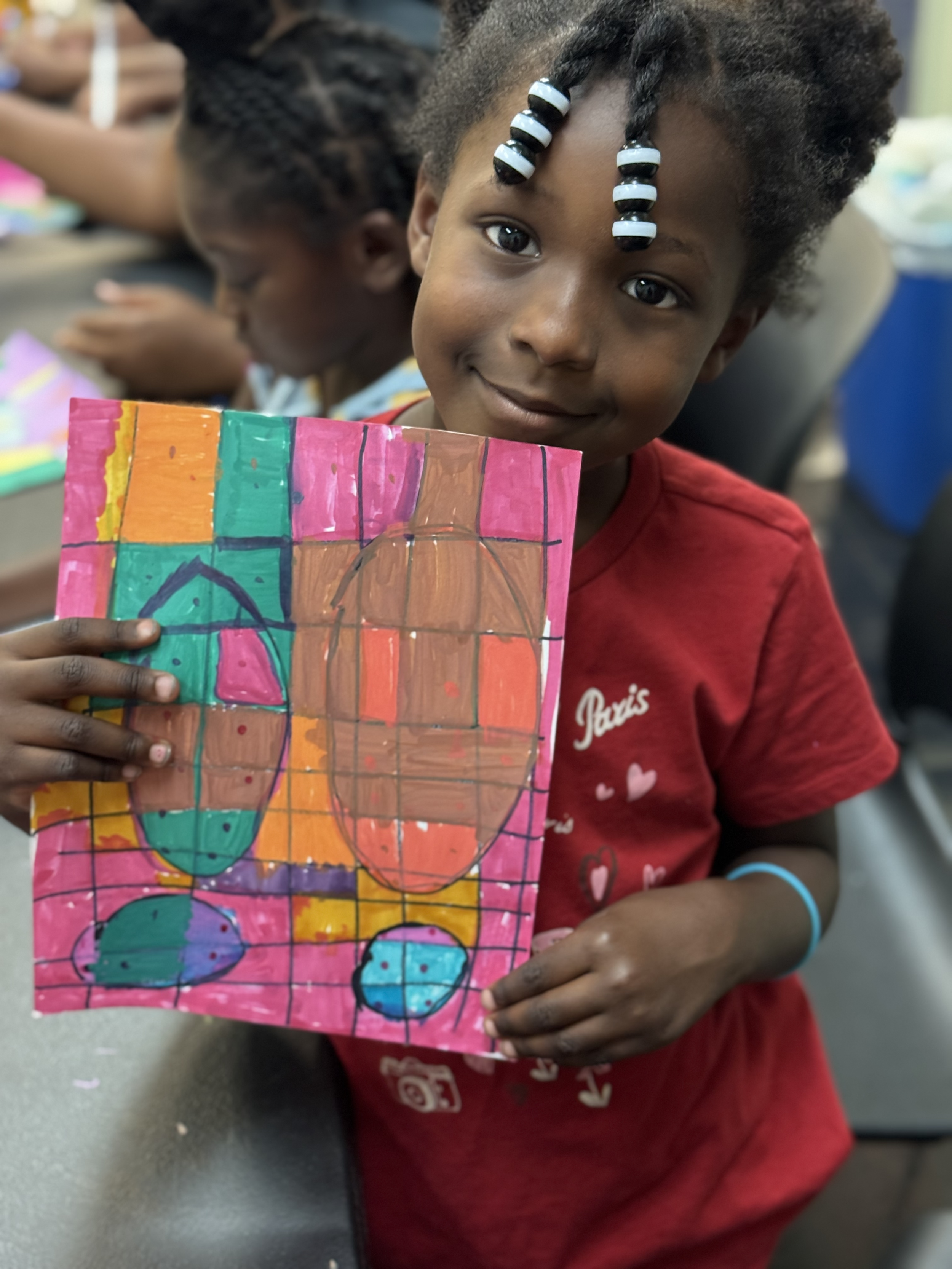 lil girl holding art cute.png