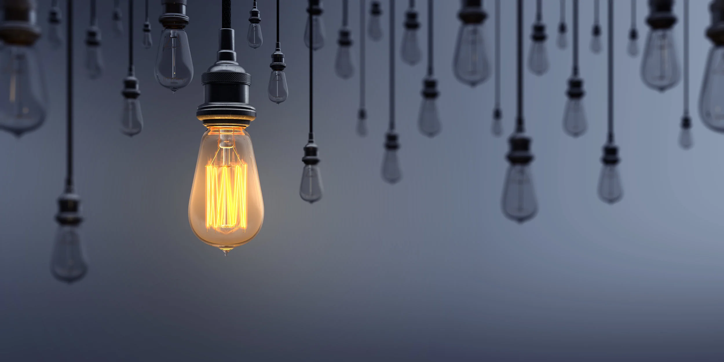 Glowing-Light-Bulb-Standing-Out-From-the-Crowd-1036100456_8000x4000.jpeg