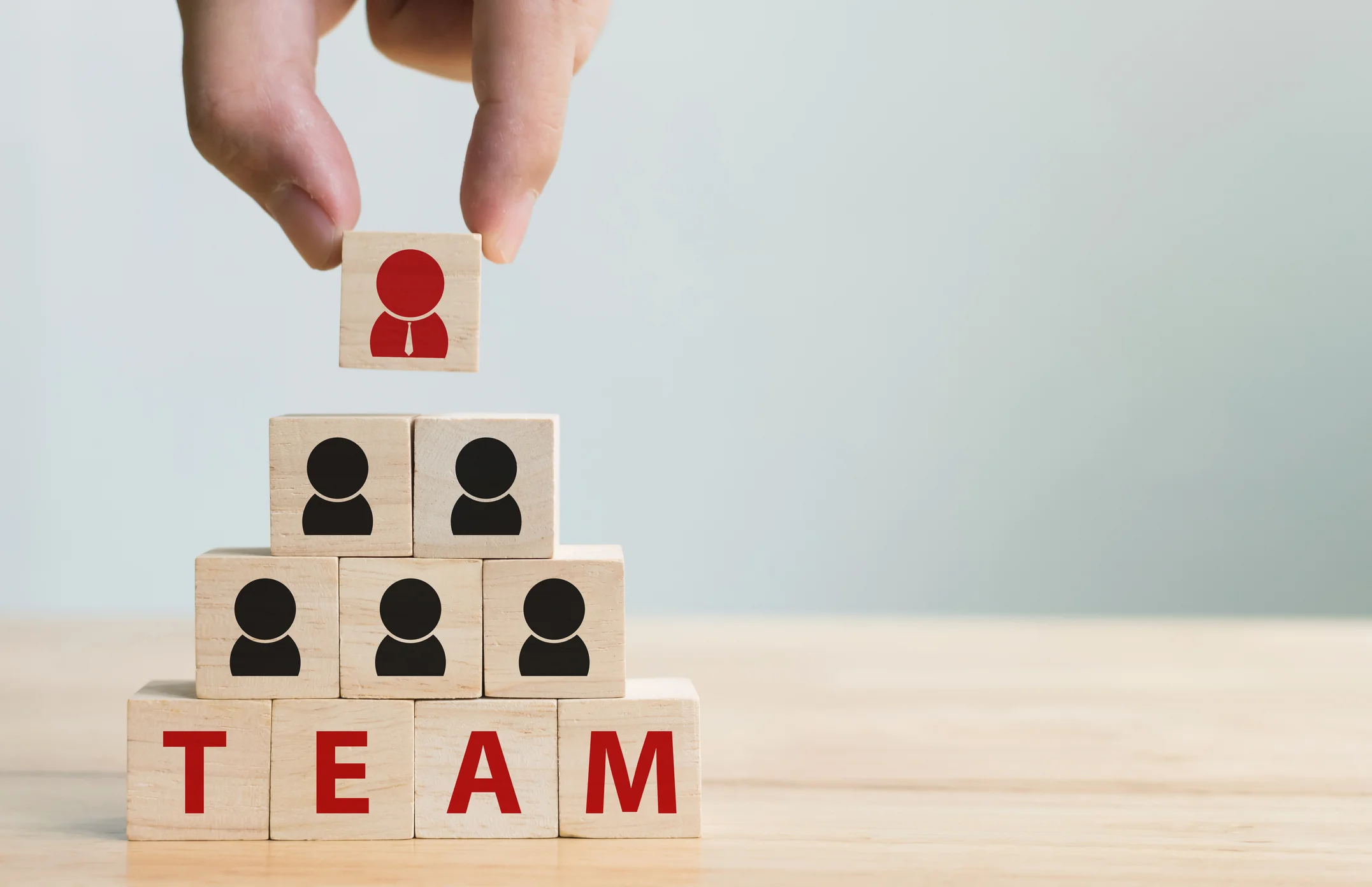 Human-resource-management-and-recruitment-business-team-concept.-Hand-putting-wood-cube-block-on-top-pyramid-1154496965_2156x1394.jpeg
