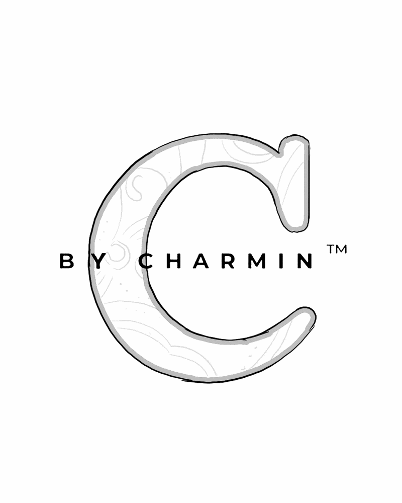 Logo with a large letter 'C' and the text 'BY CHARMIN' inside and outside the letter.
