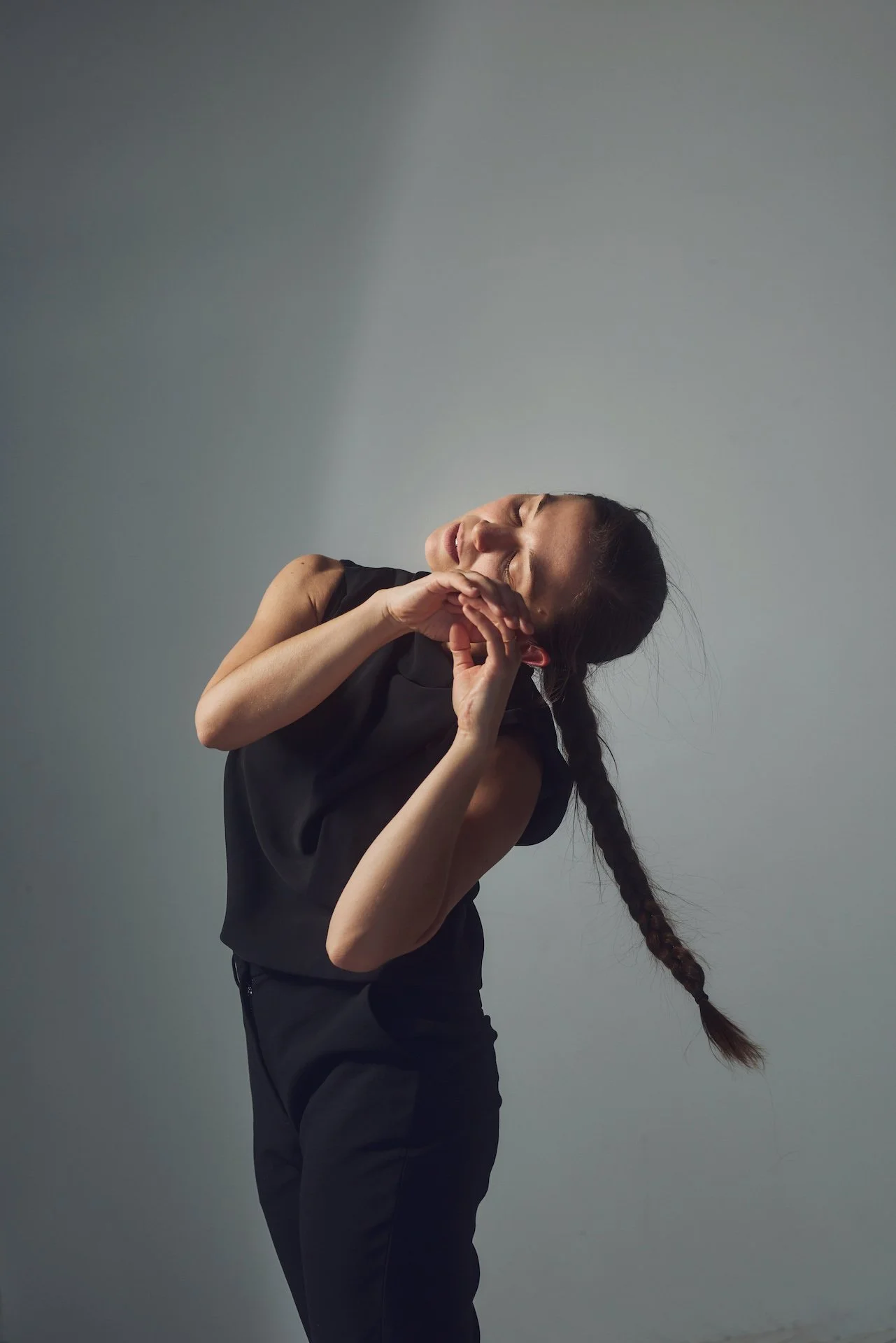 Image of Nicole von Arx dancing in front of a white wall.