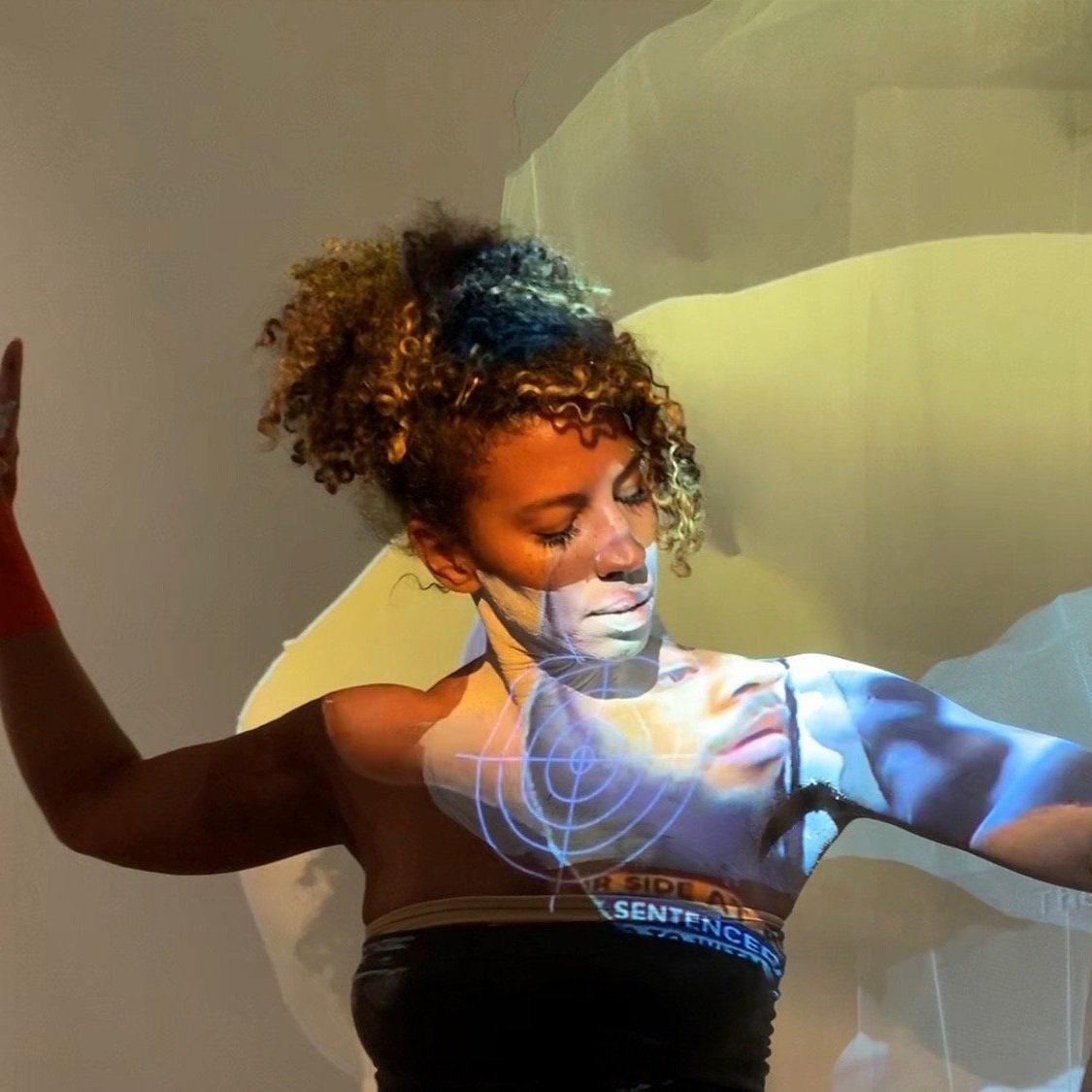 Image of Miriam Parker with projections on her.