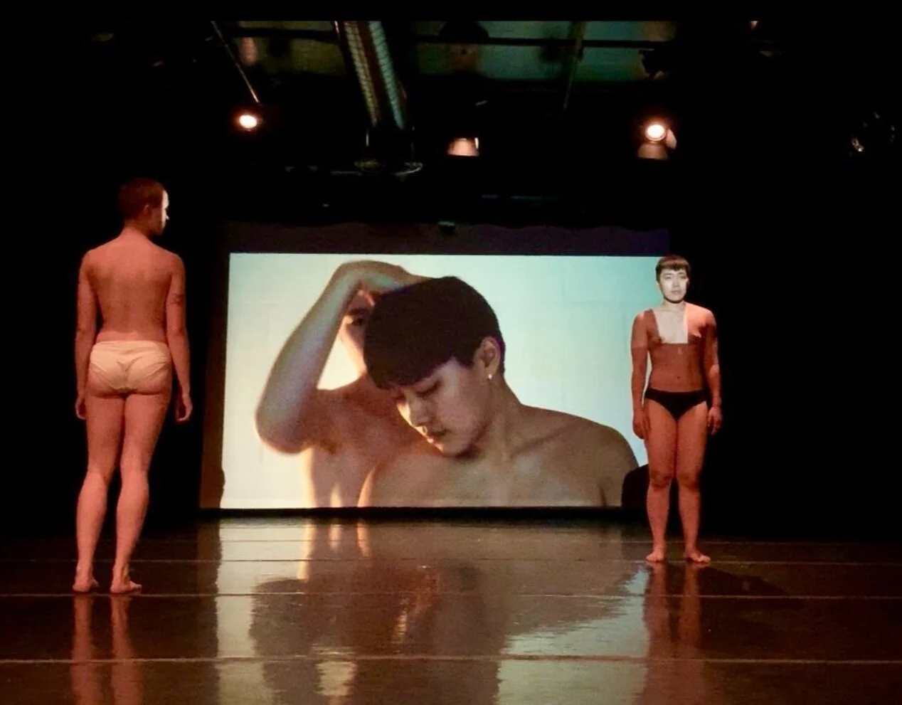 Photo of Shannon Yu and Maya LaLiberté in front of a projection