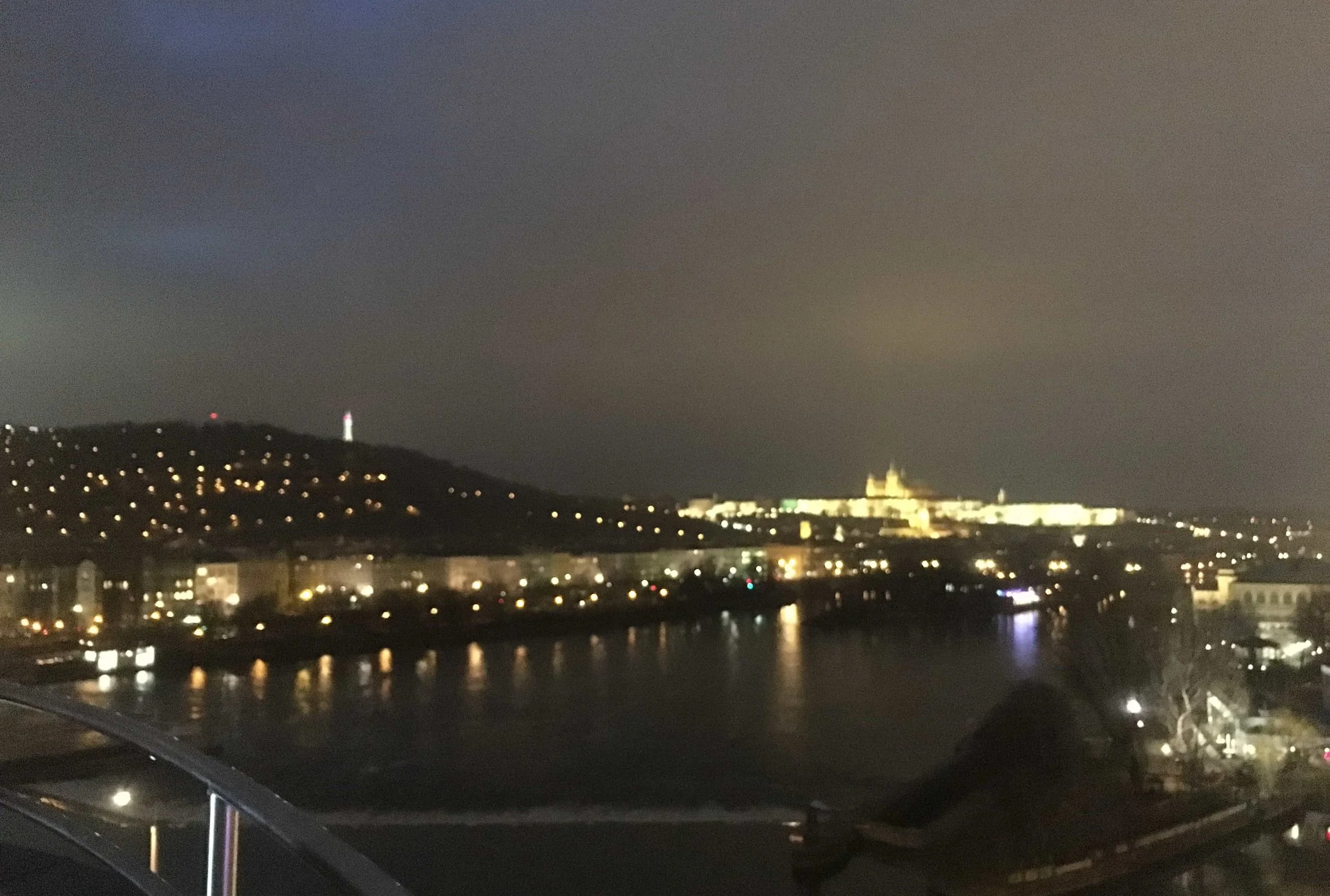 prague lit up at night on the water