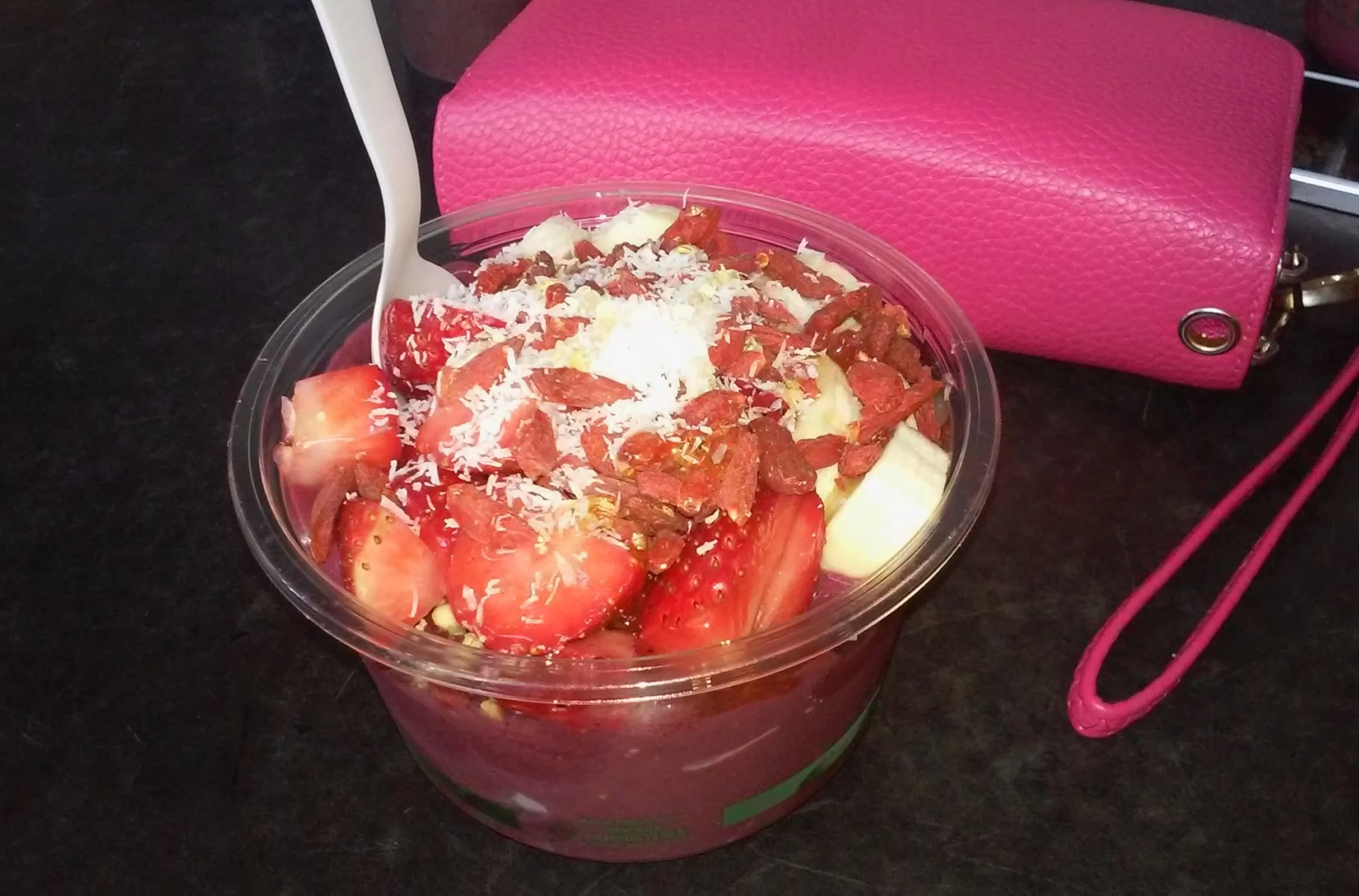 acai bowl with hot pink wallet