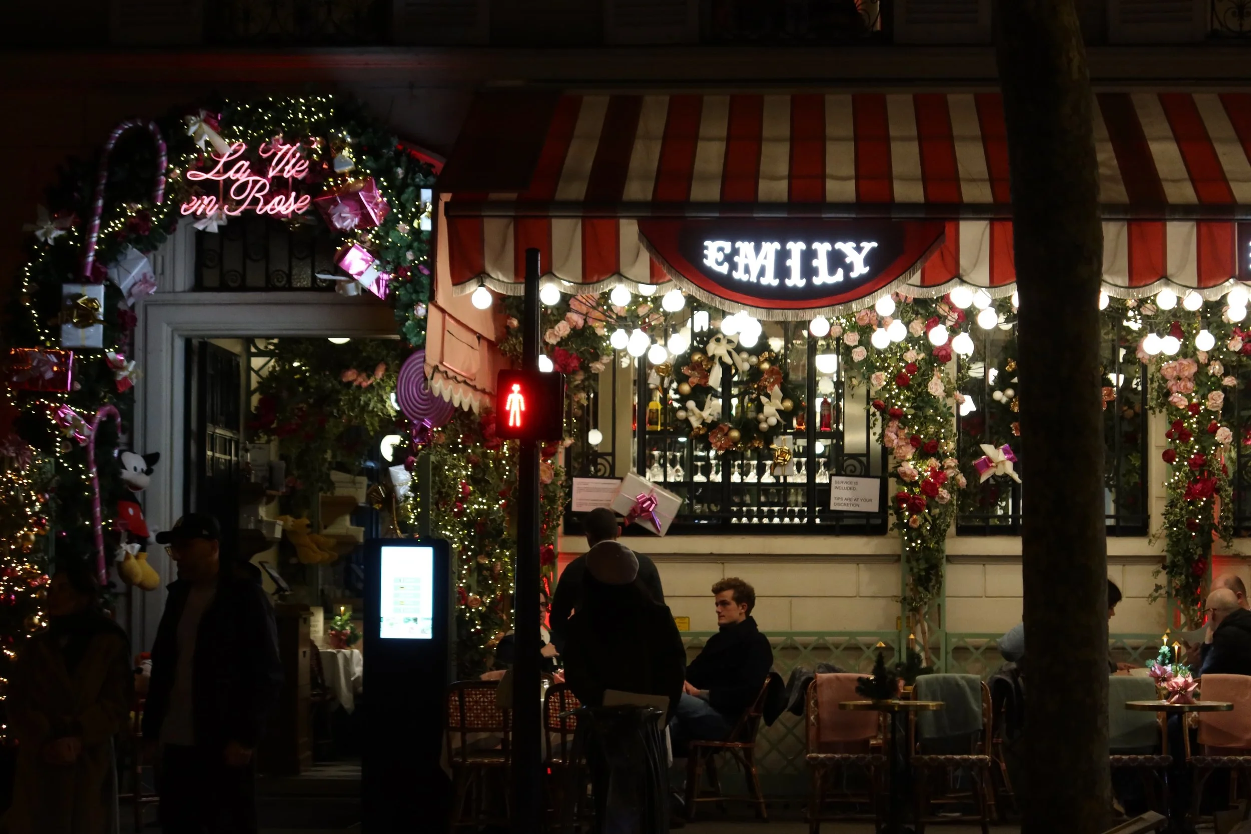 View of Emily in Paris themed café near Eiffel Tower at night; December 2025