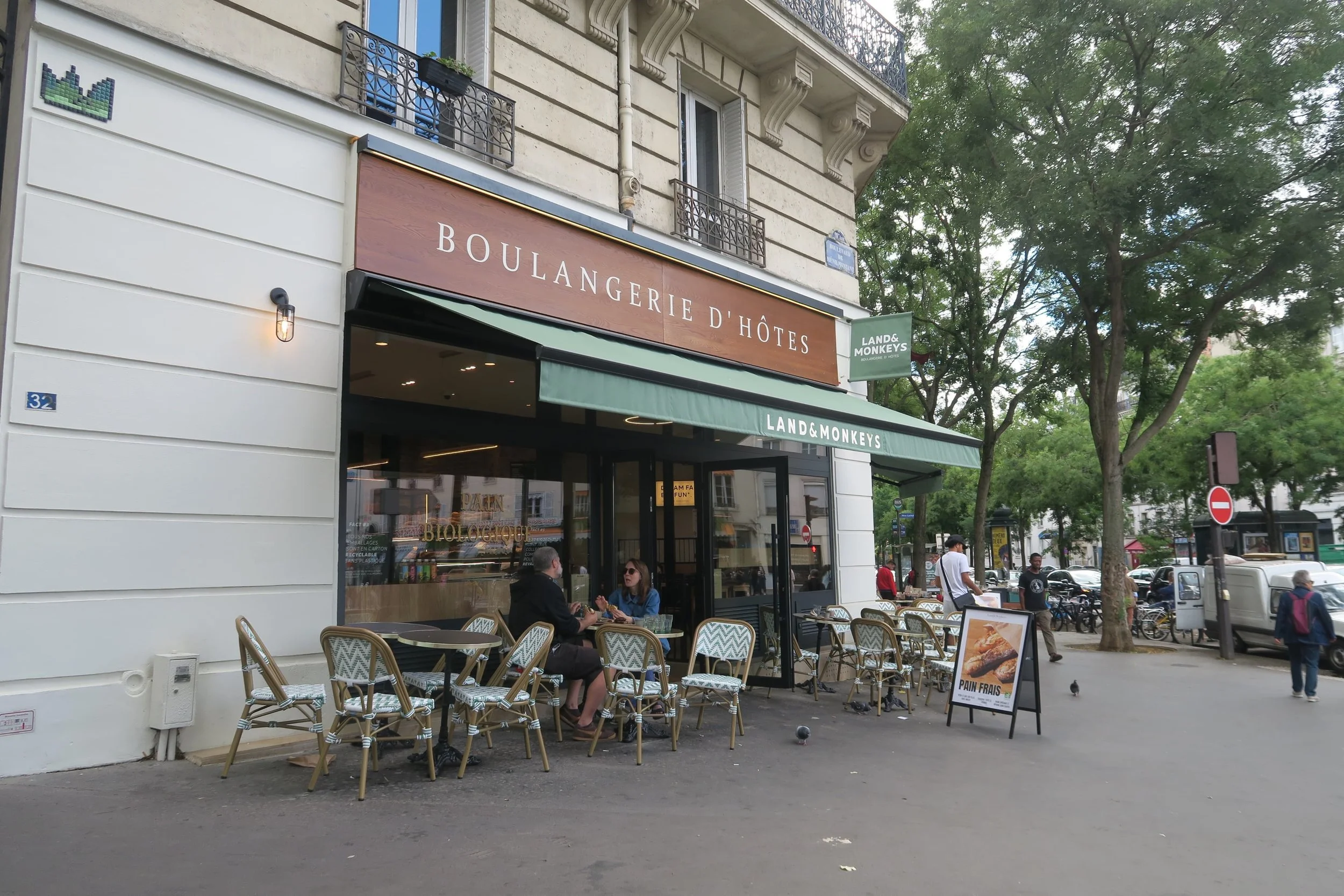 outside bakery with light green chairs and awning