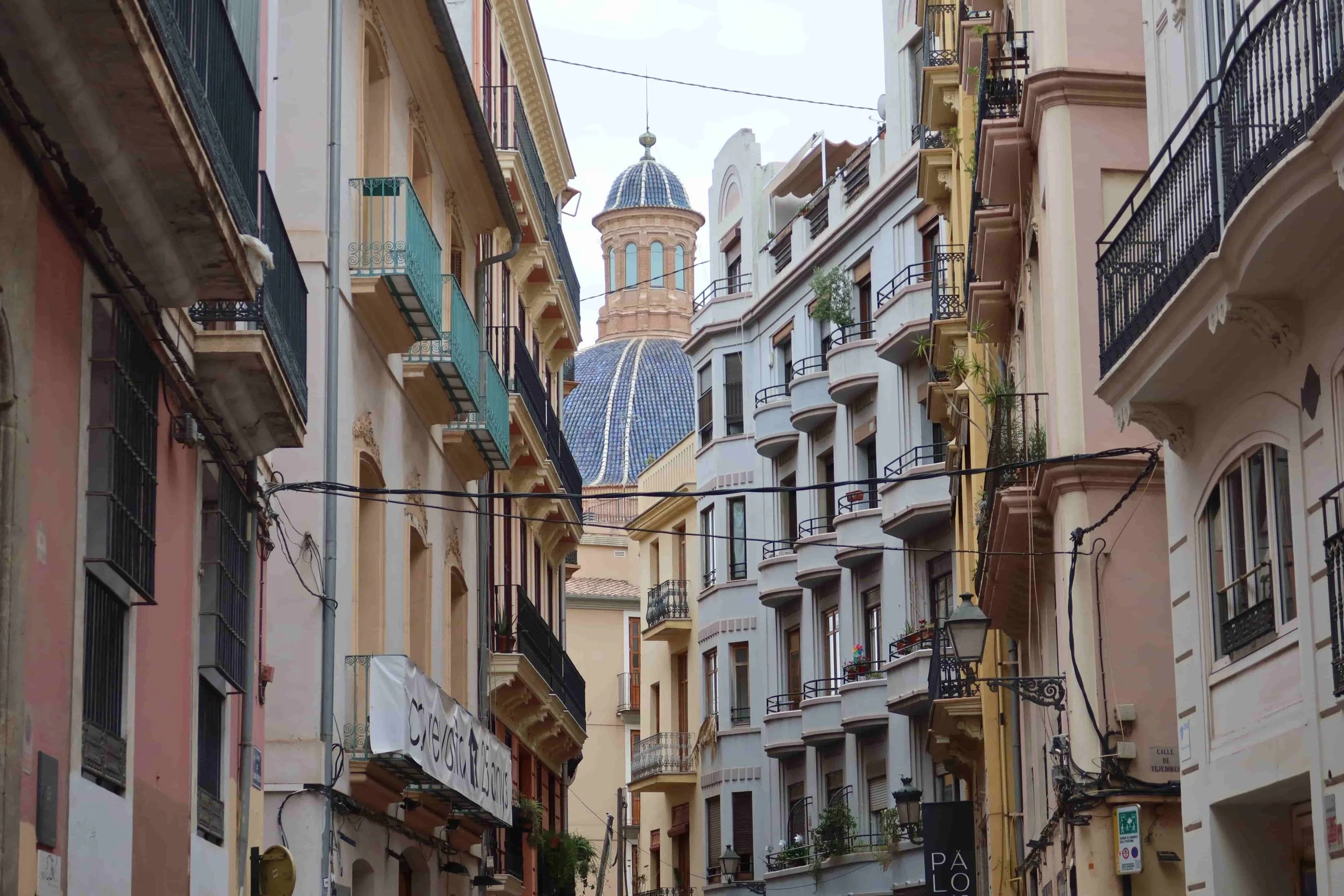 blue dome building and colorful buildings in narrow street