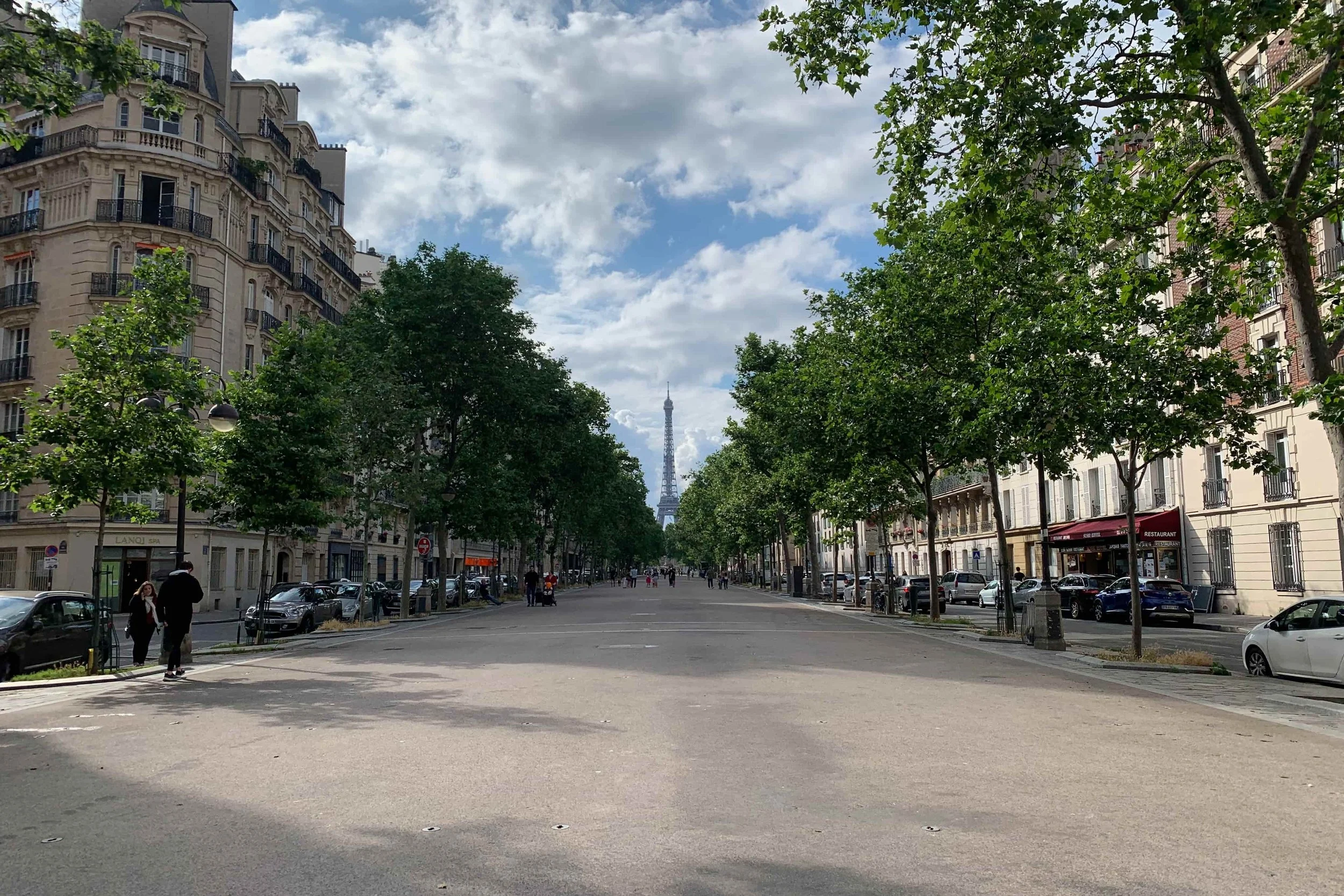 dead center view of eiffel tower on quiet street
