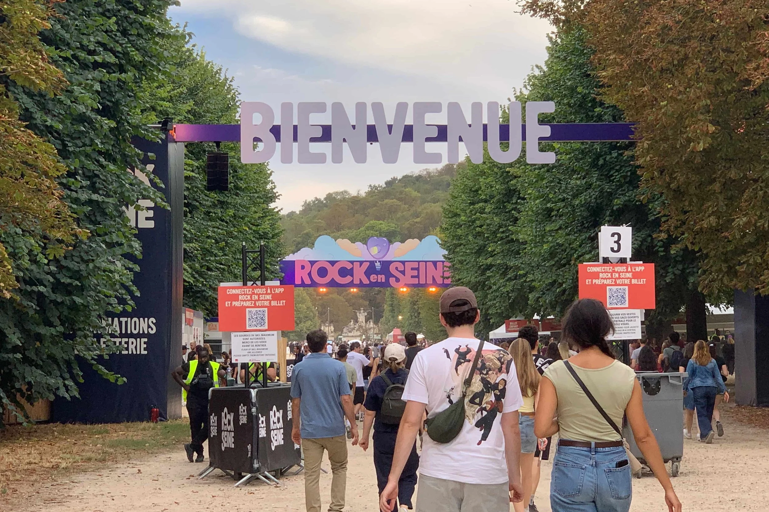 entrance into music festival people and colorful signs