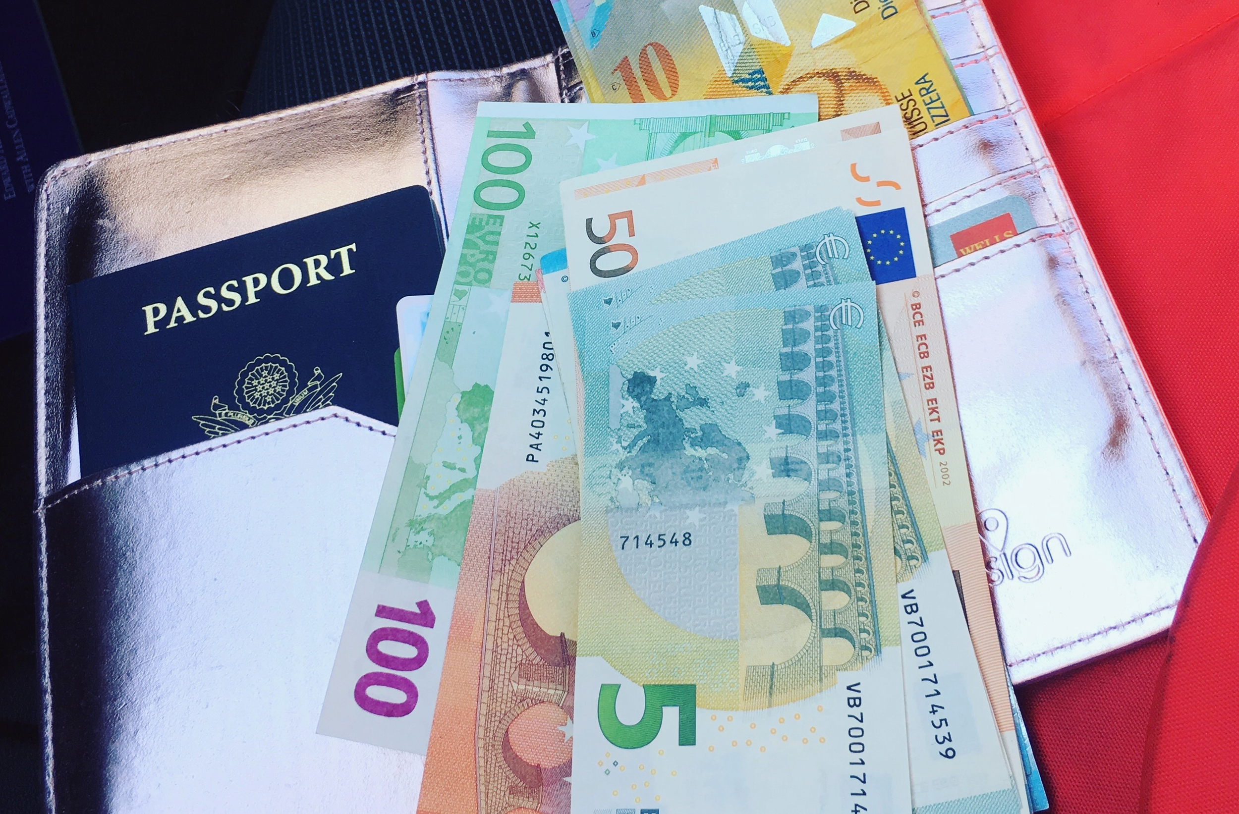 U.S. passport in pink case with various euro bills