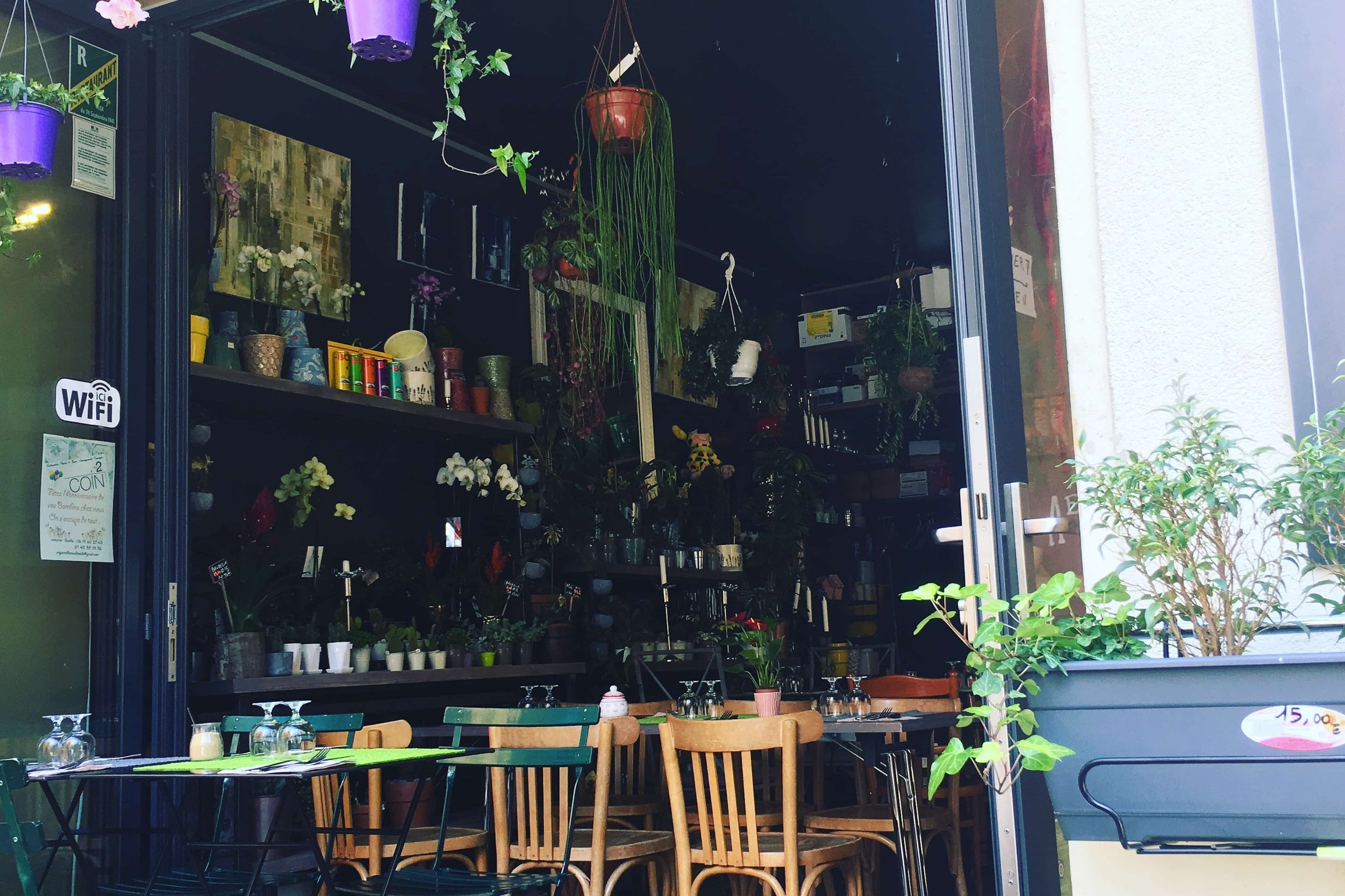 cafe in small square spot tan chairs and plants