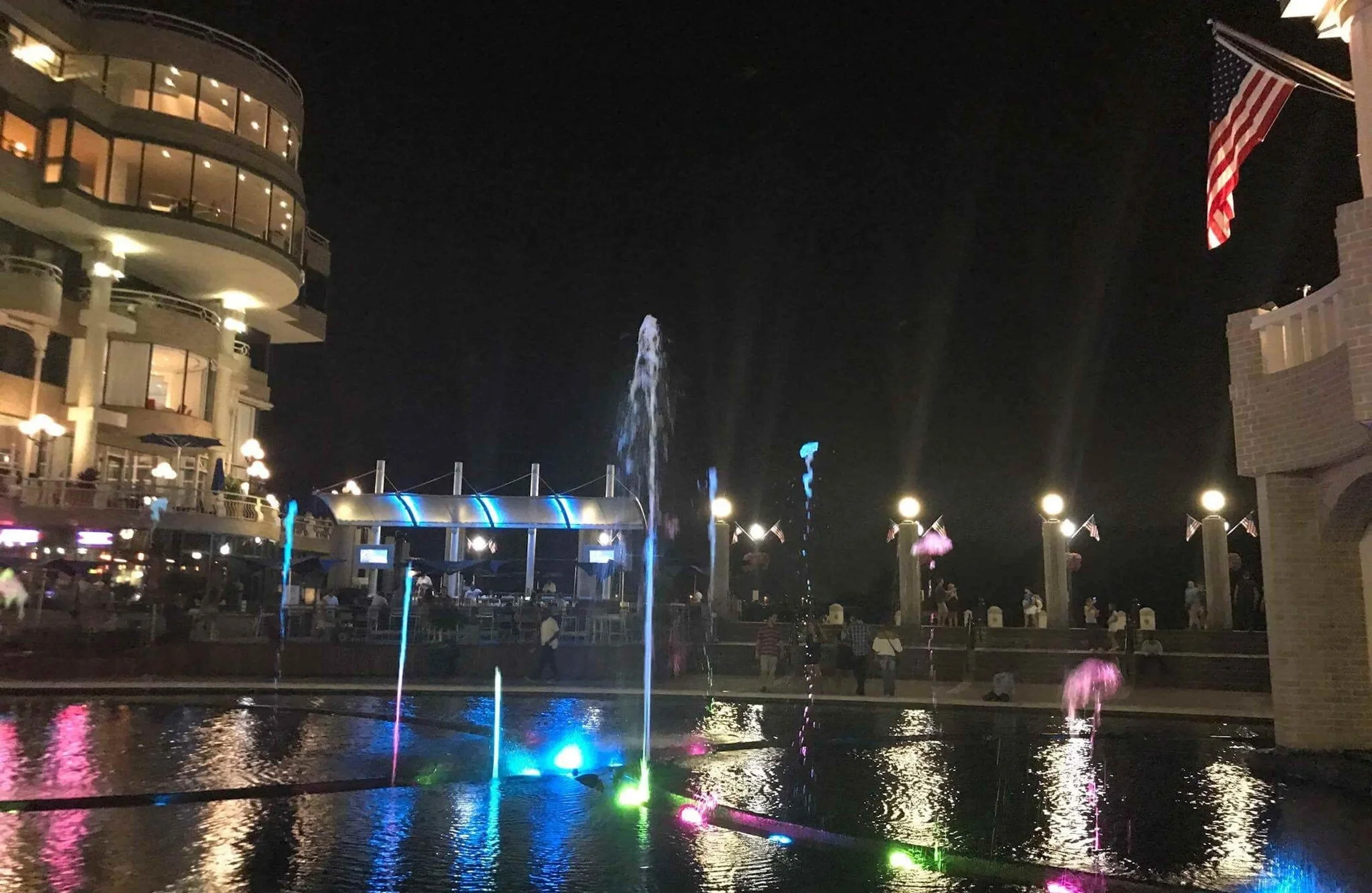 waterfront with colorful lights at night