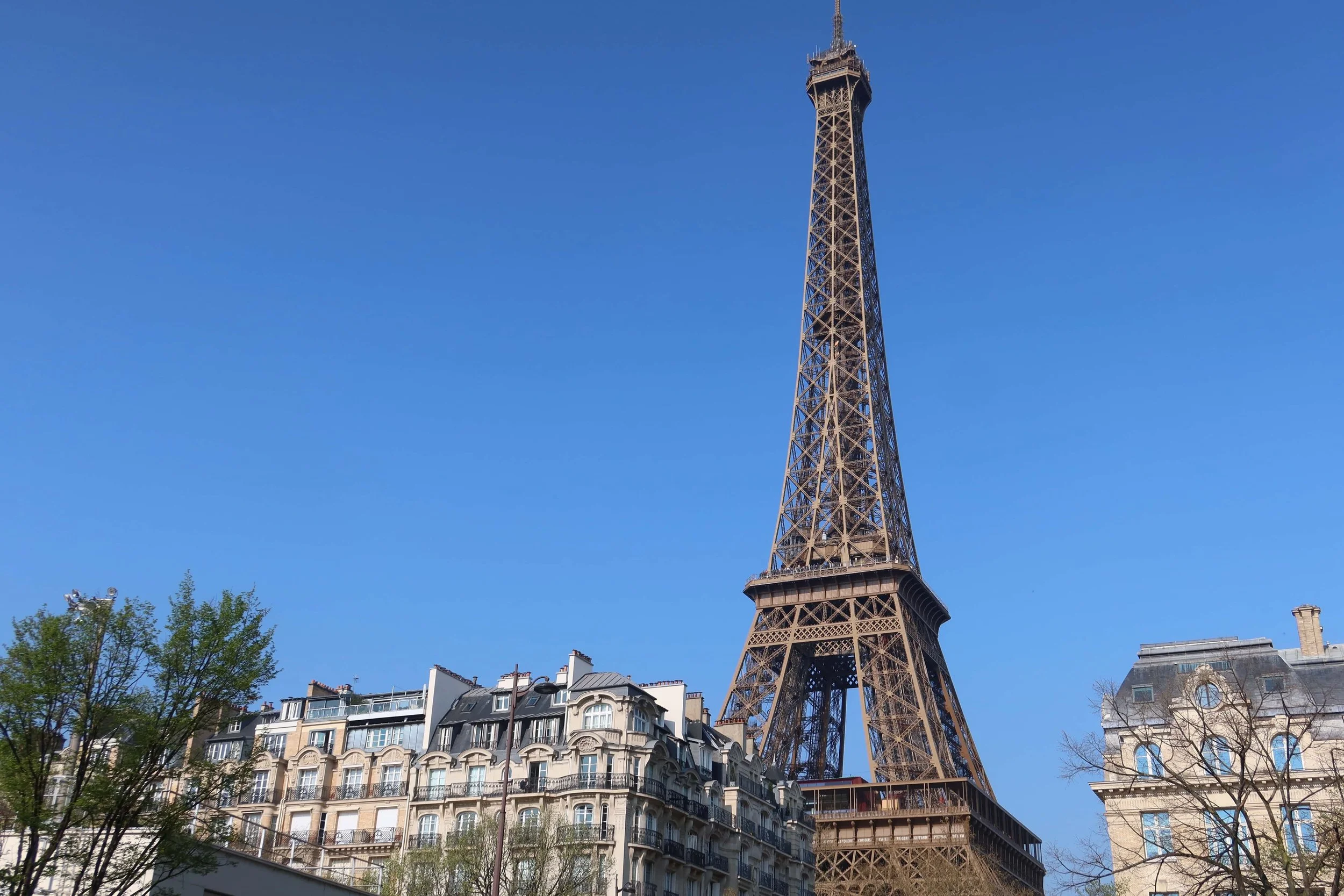 eiffel tower on blue sky day with strong sun