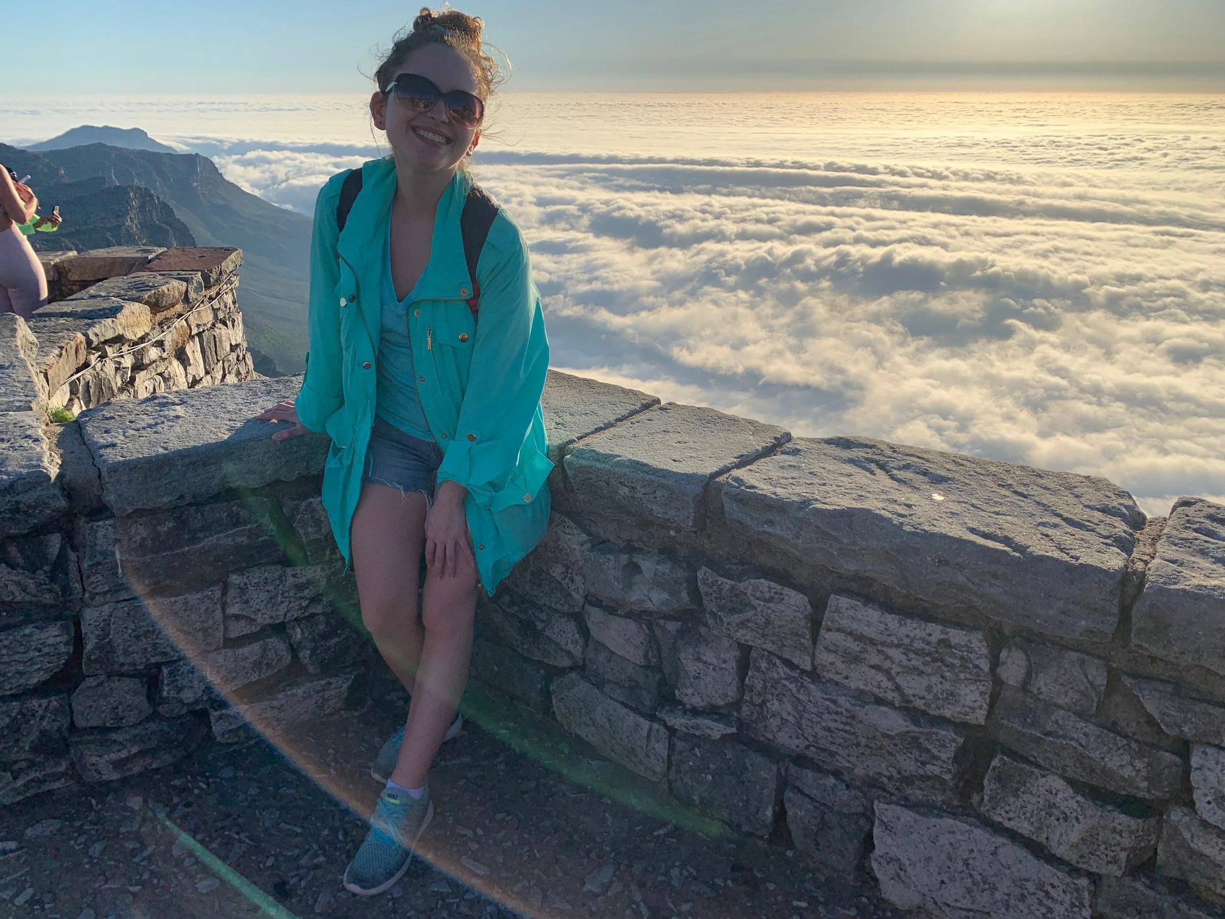girl wearing teal coat top of table mountain