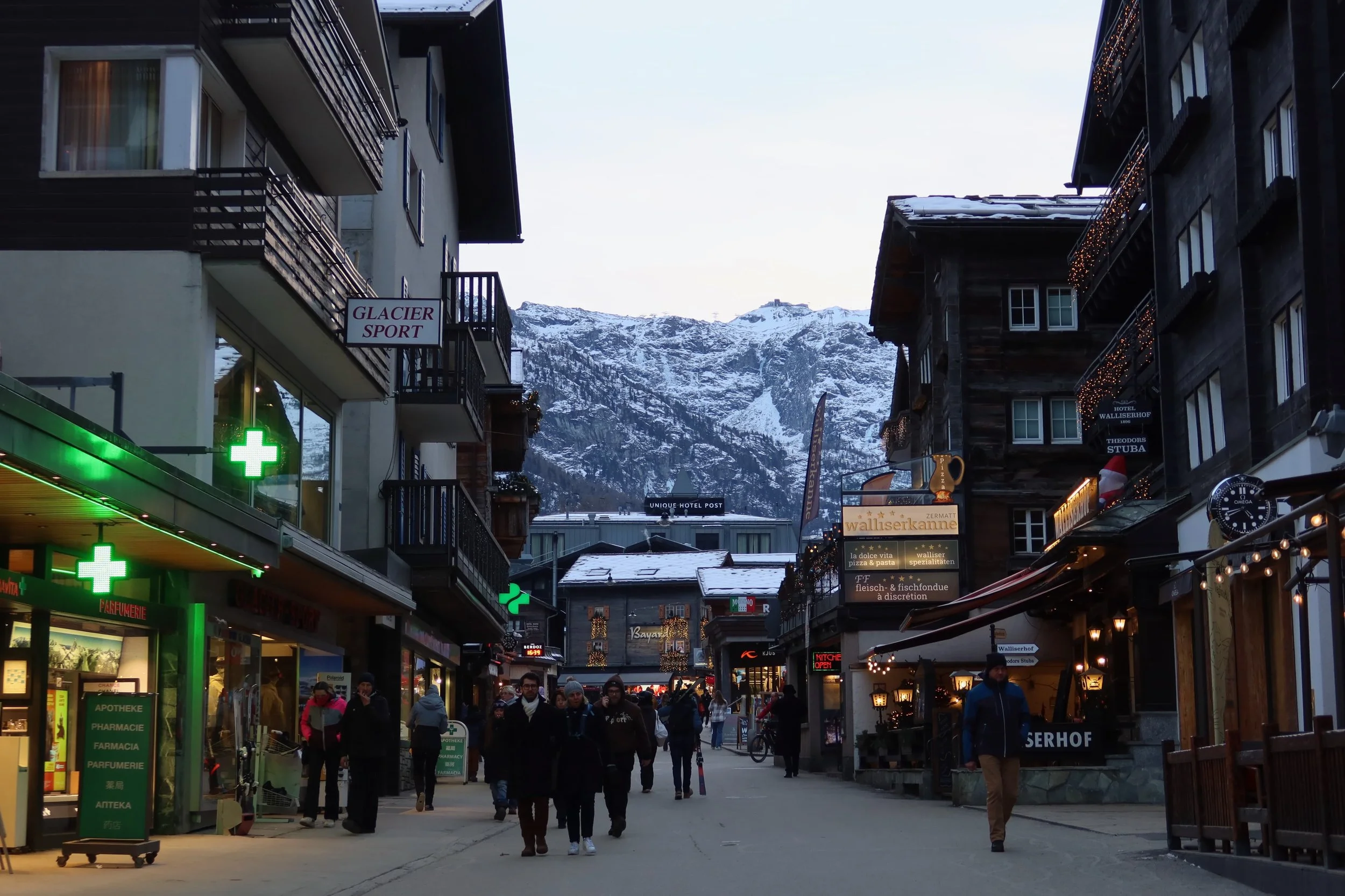 main shopping street with snowy mountains behind