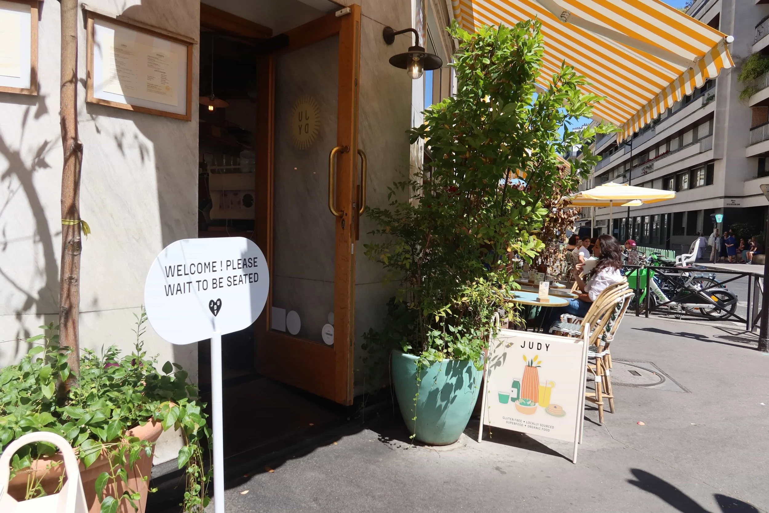 cute chairs and yellow awning cafe