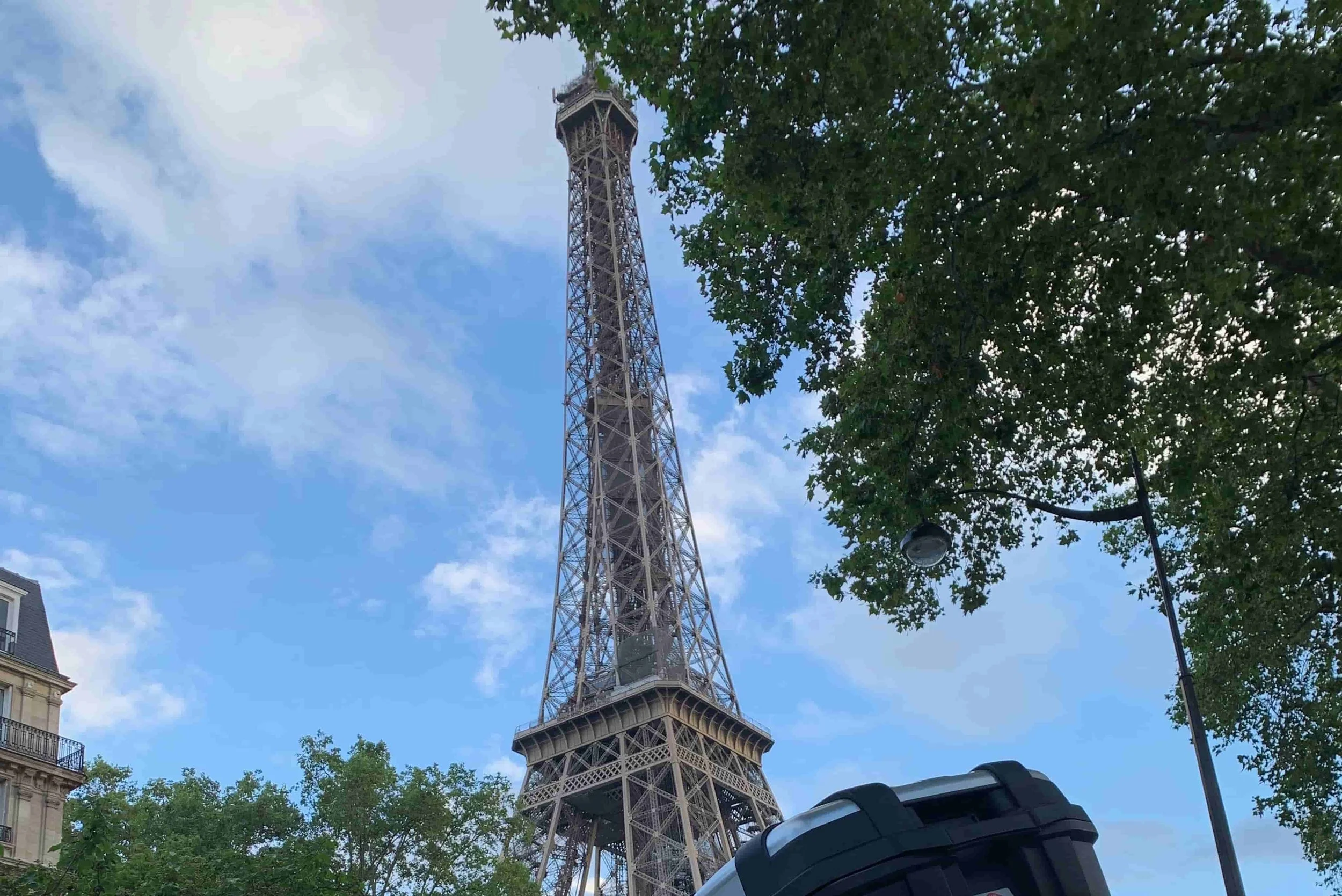 eiffel tower with leafy green trees and blue sky