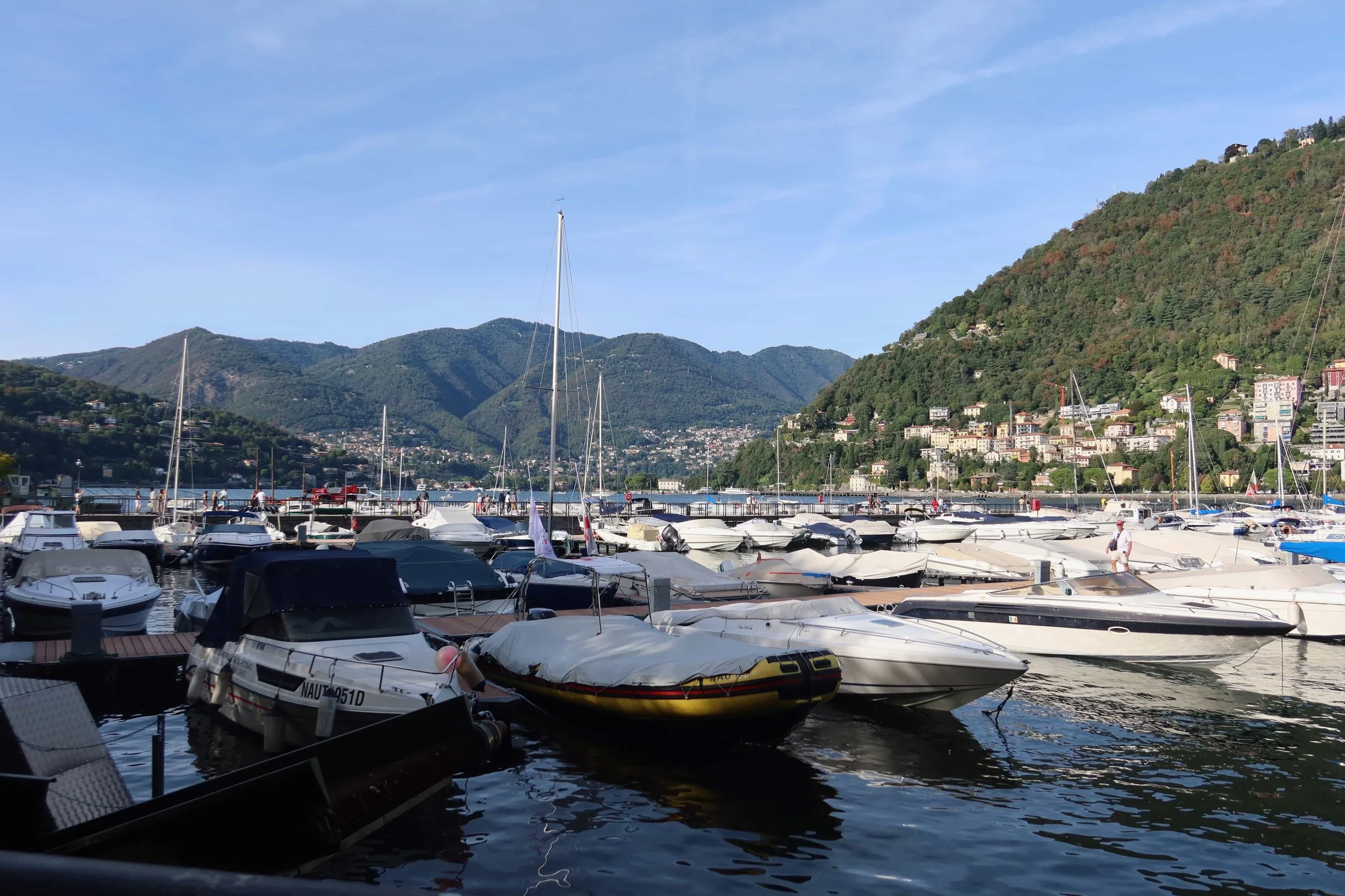 boats on water with mountains behind