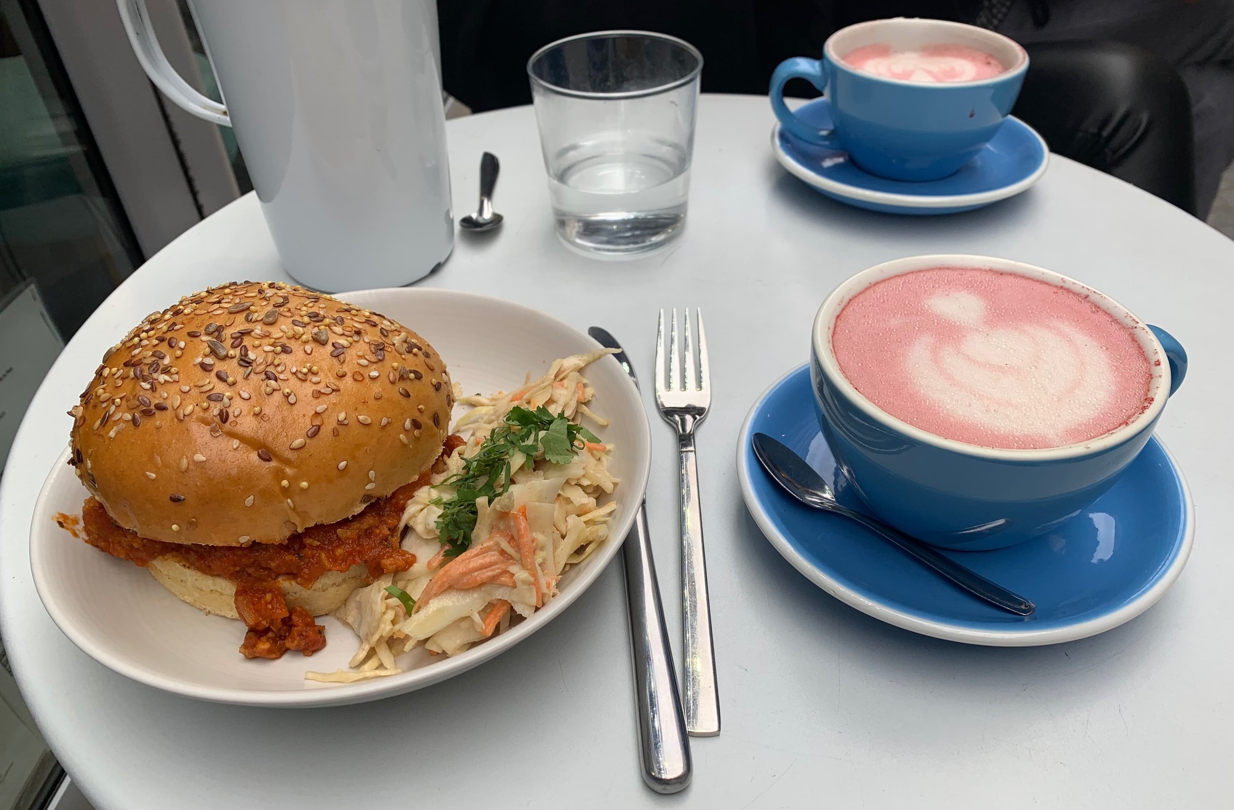 beetroot lattees and sloppy joe with coleslaw on white table