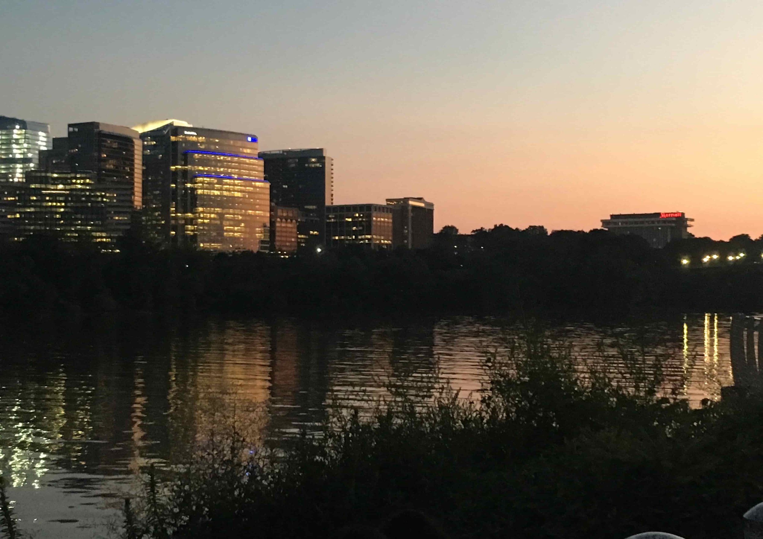 sunset on waterfront with modern buildings