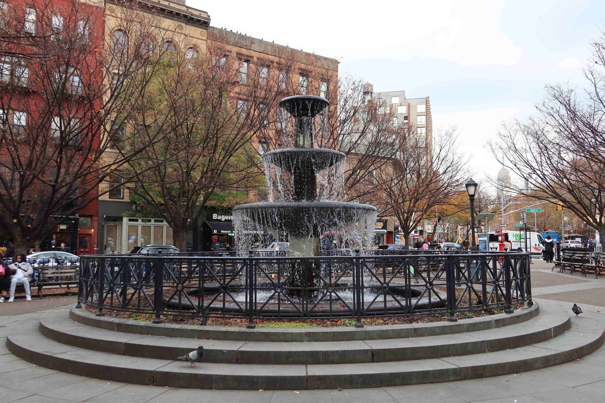 fountain with empire state building in background