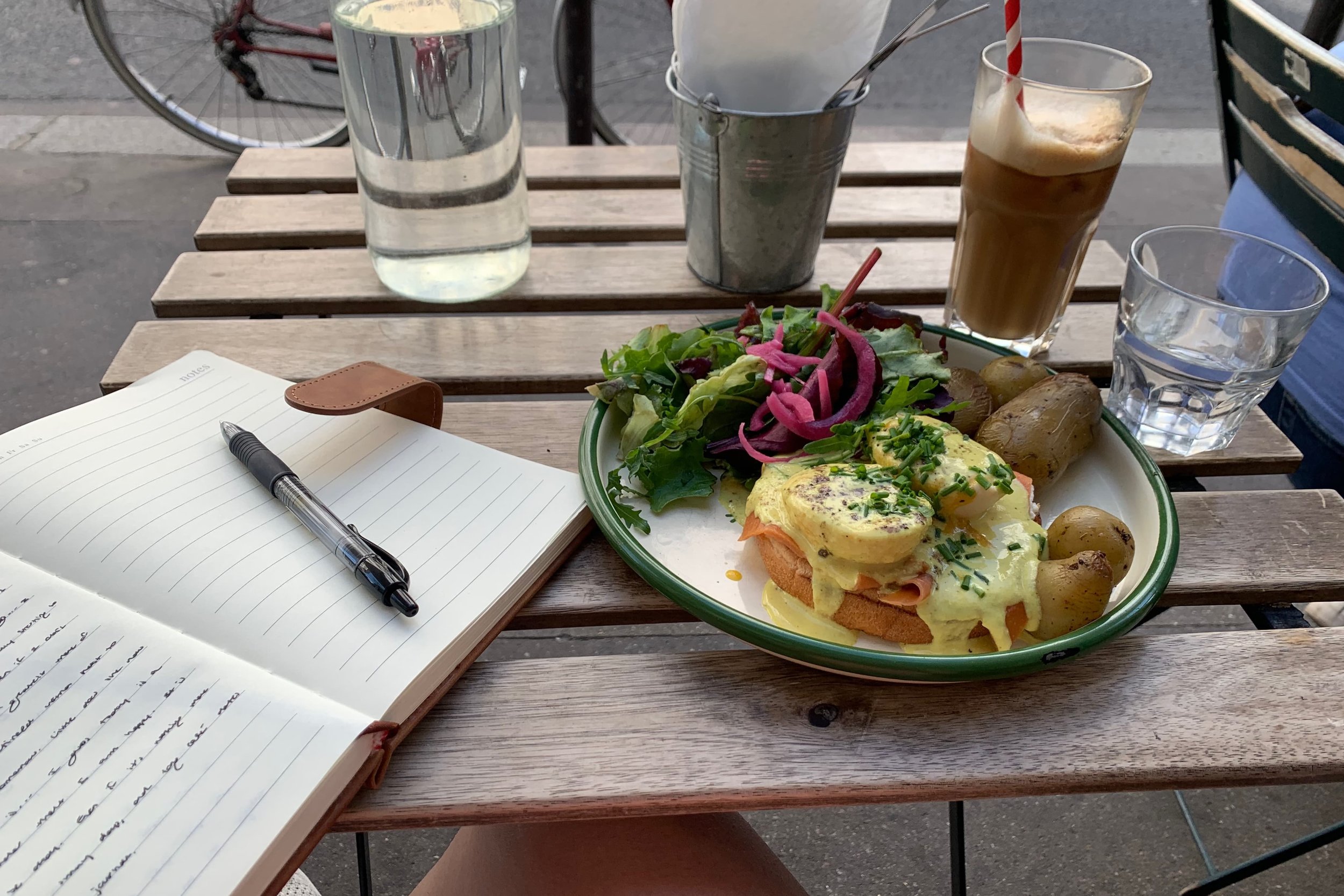 brunch plate with iced latte and journal