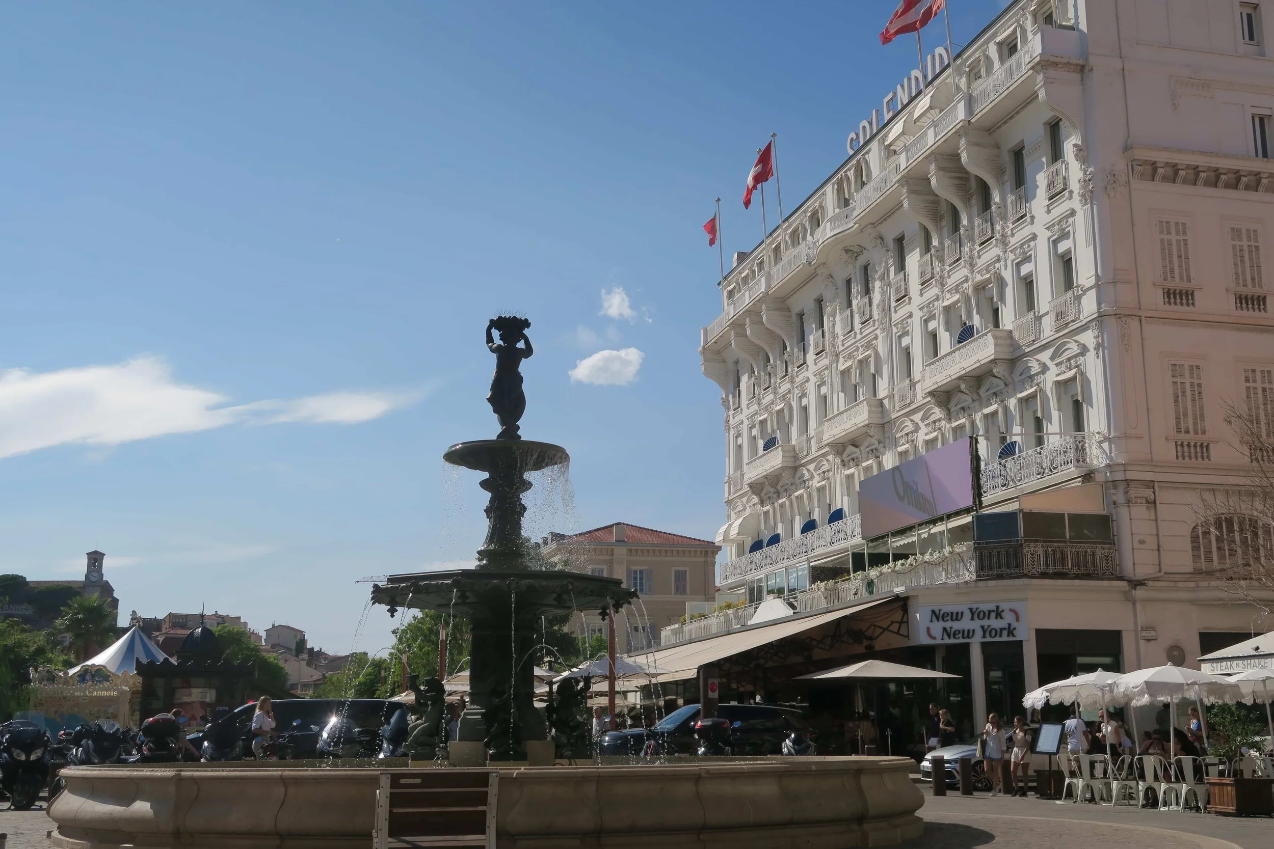 black fountain with manicured white building