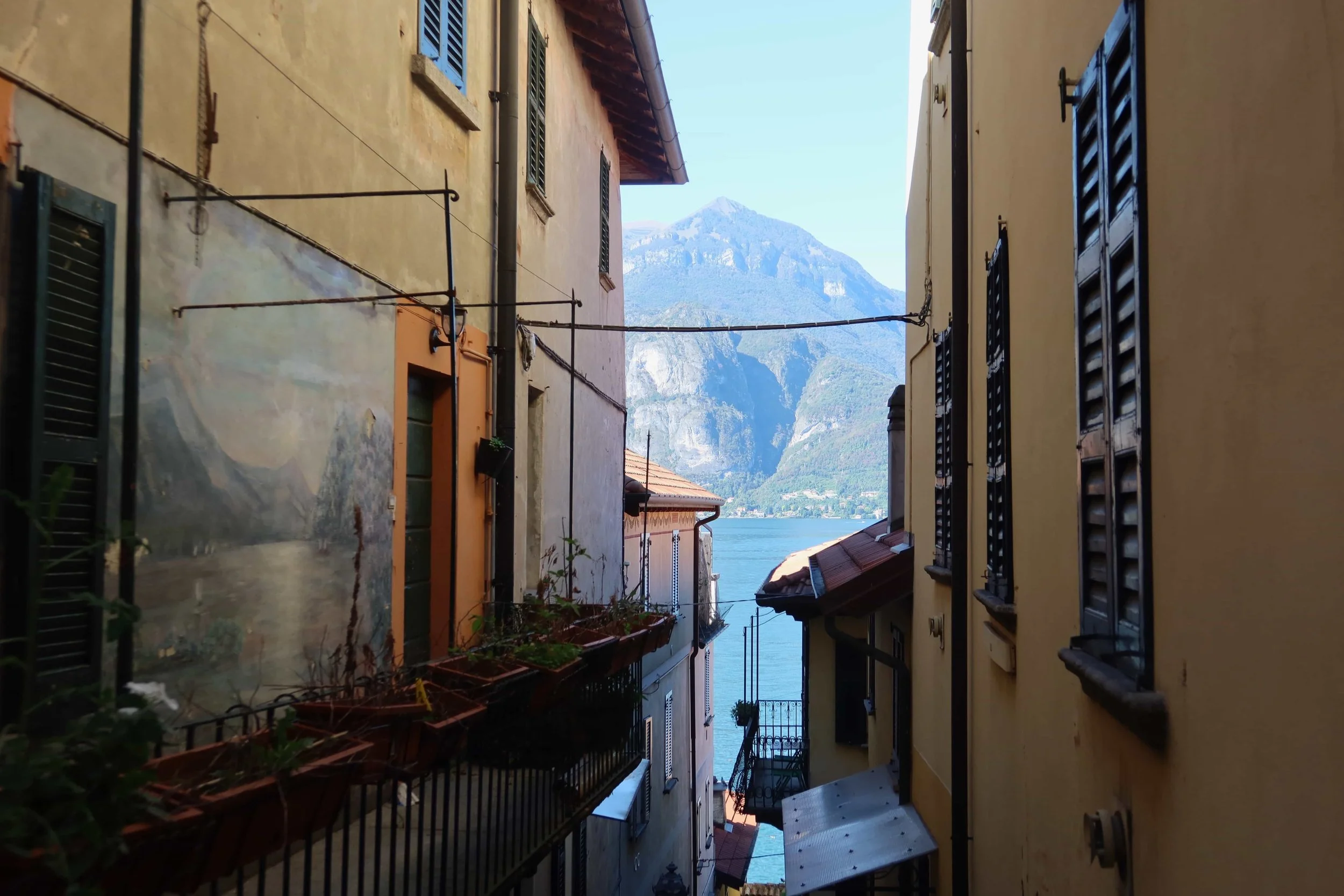 mountain and water in between orange houses