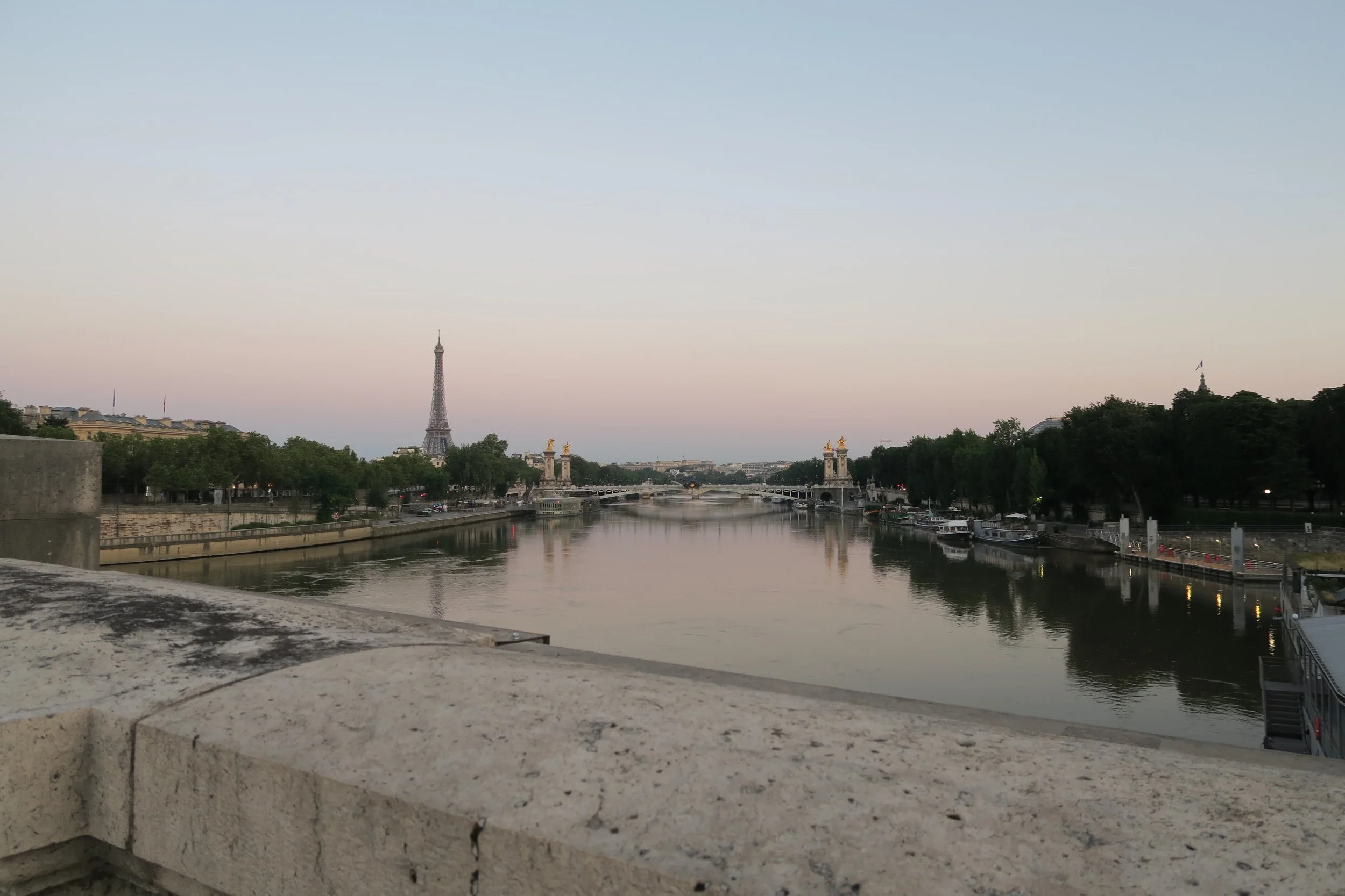 sunrise view of paris on water and eiffel tower famous pont alexnadre iii bridge white and gold