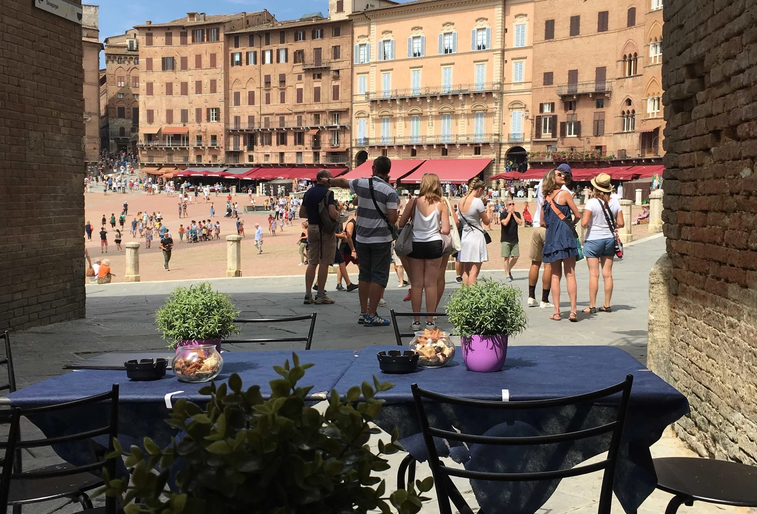 busy plaza in italy from table lots of people