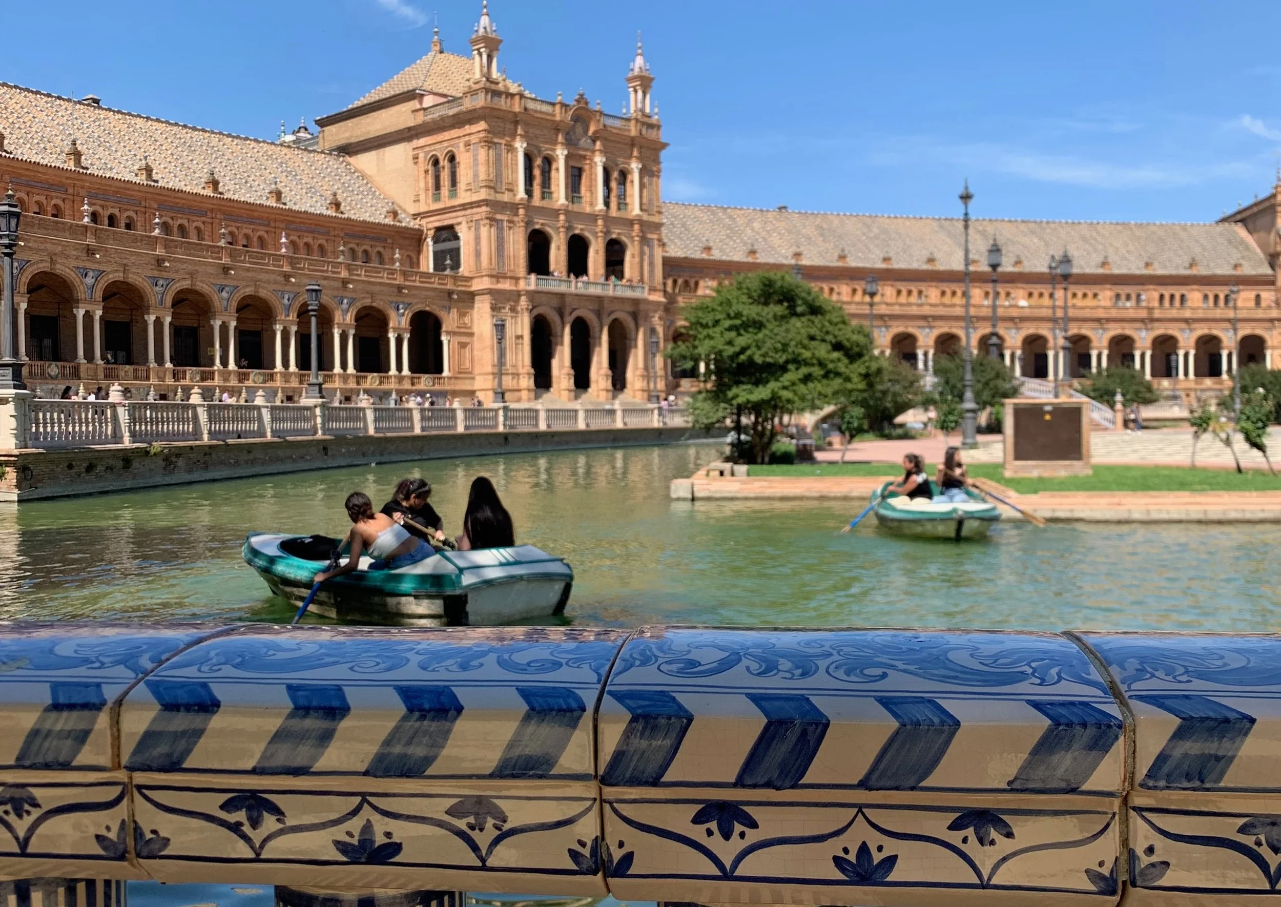 plaza de espana seville with boats and pond