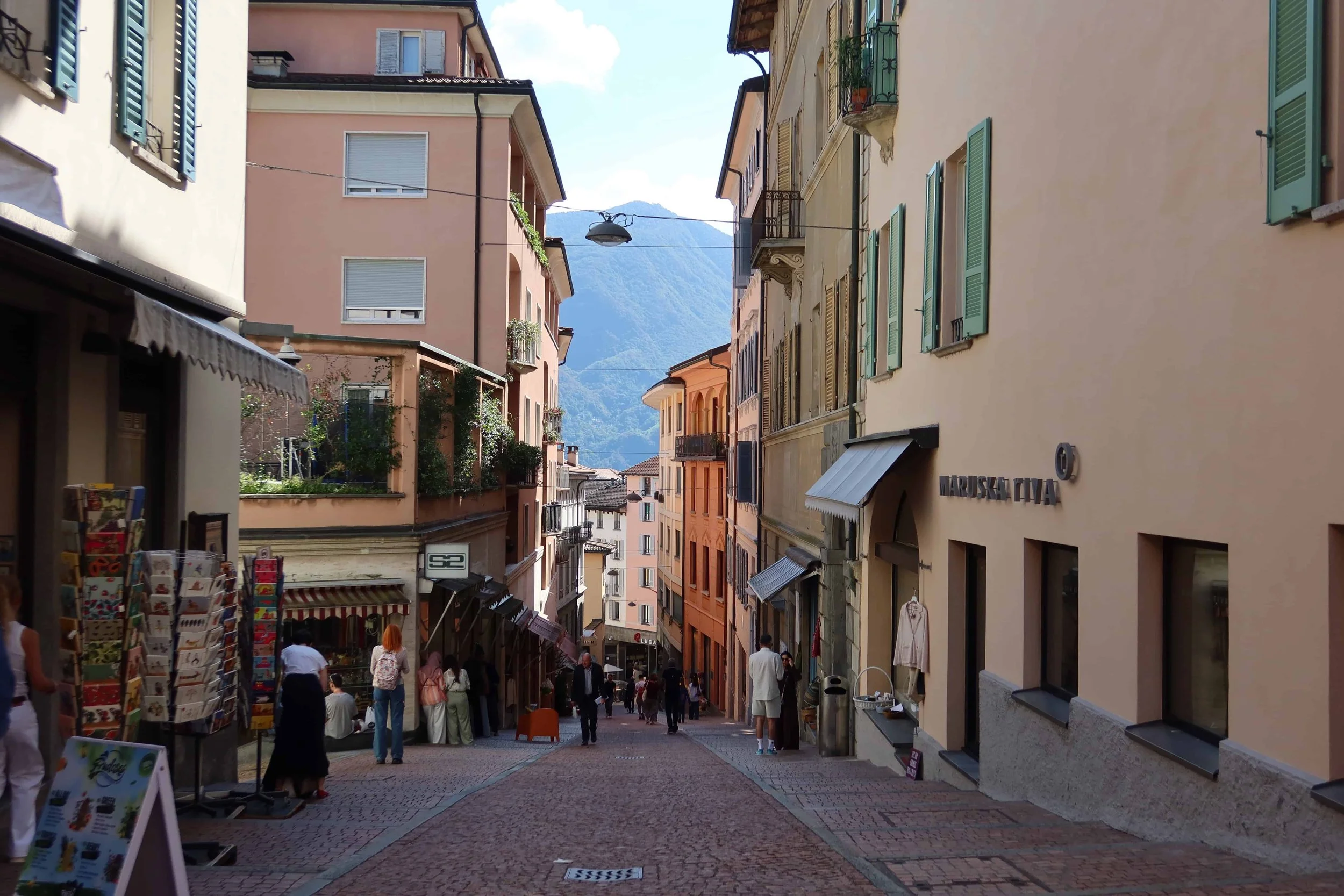colorful hilly street with mountains in the distance