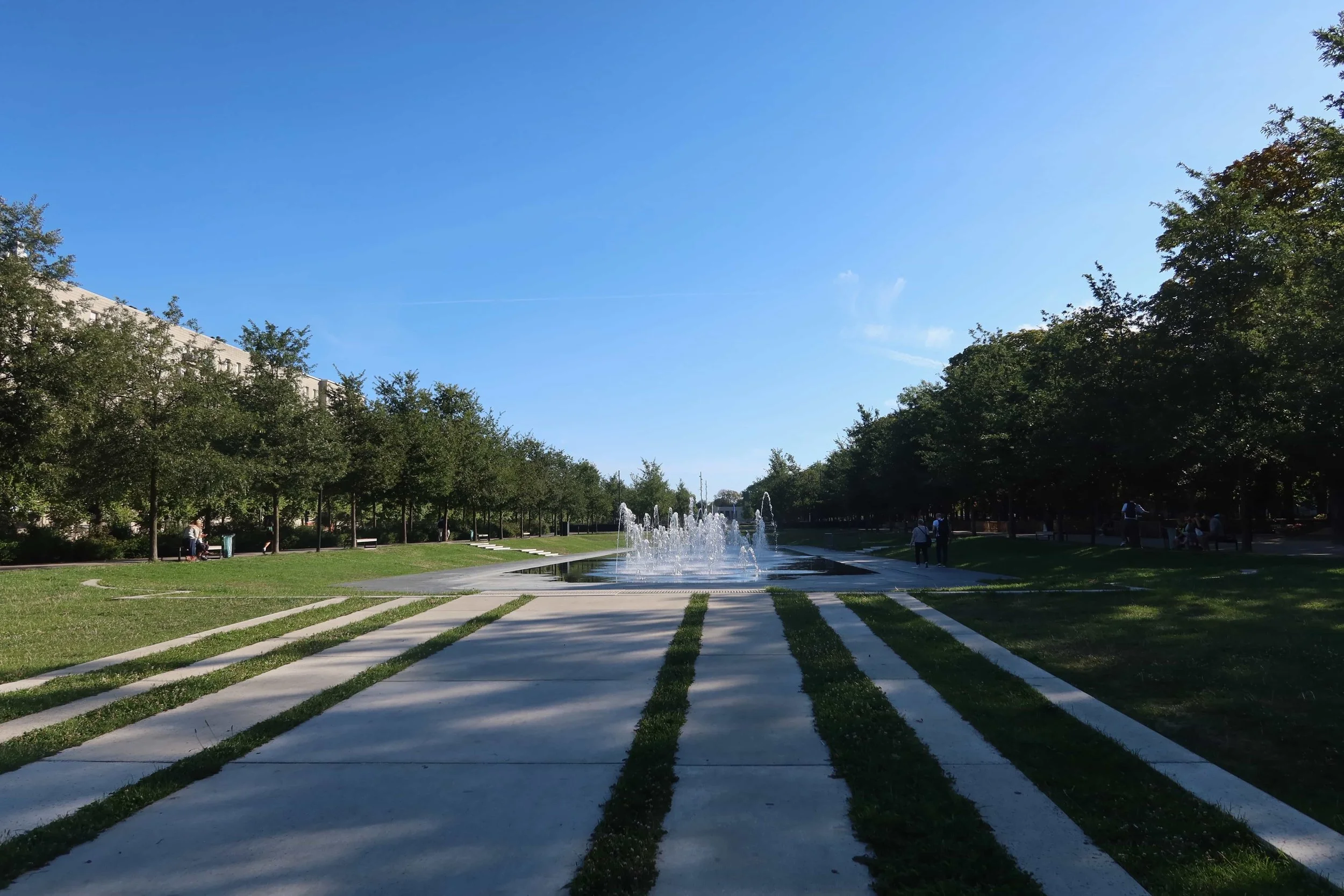 green grass walkway with ground-water jets