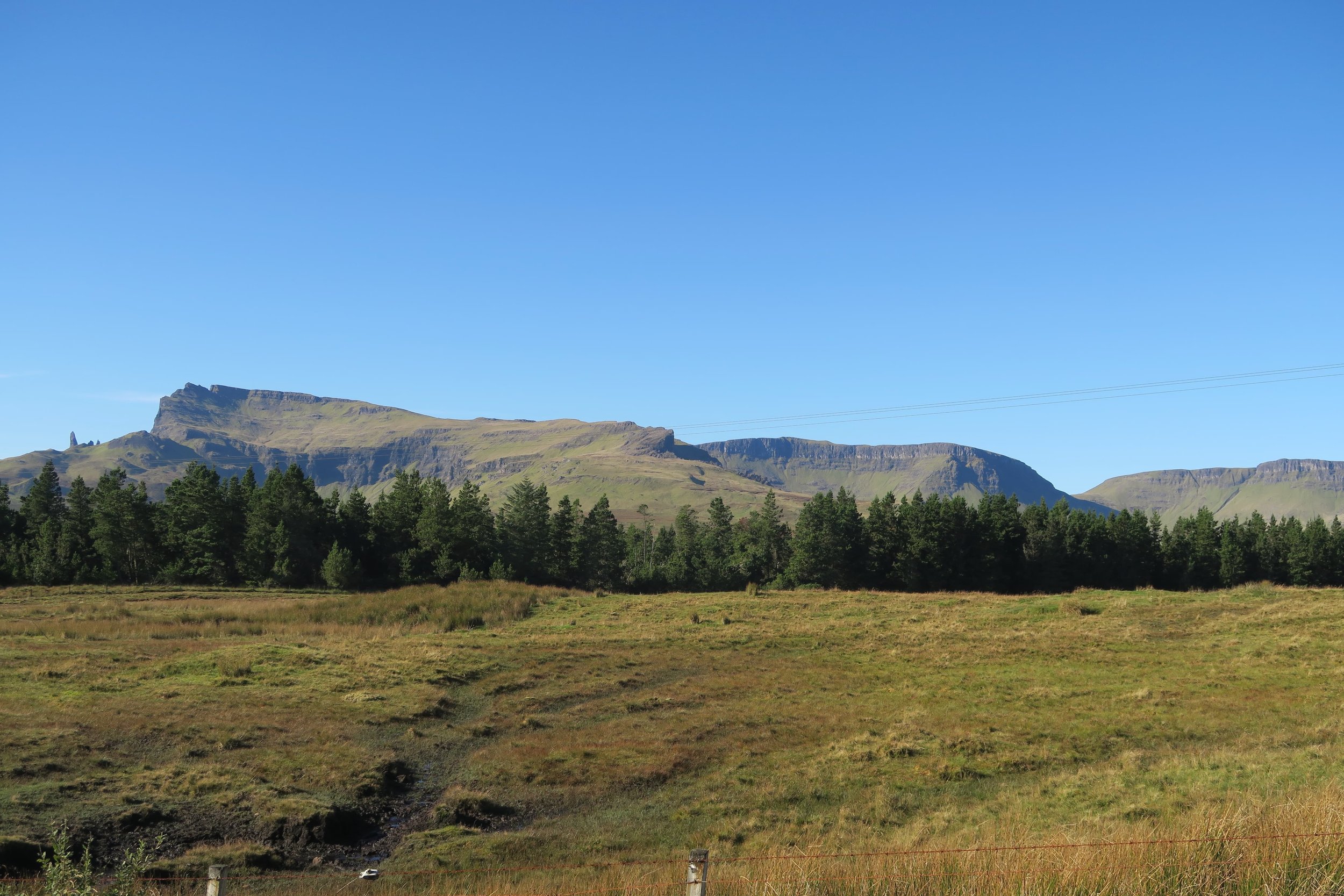 green and brown rock mountain on the isle of skye scotland