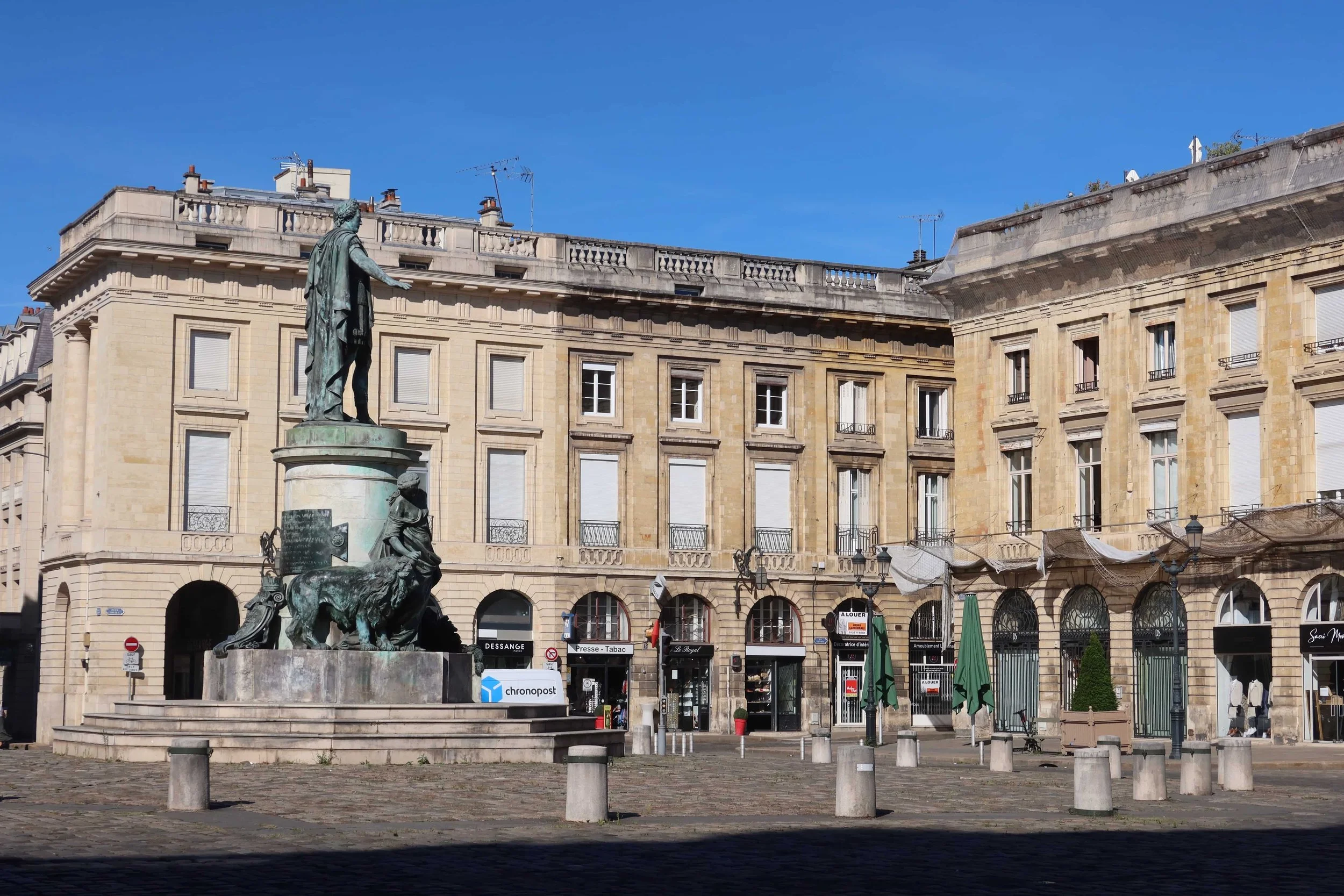 statue and cafes lines in old square