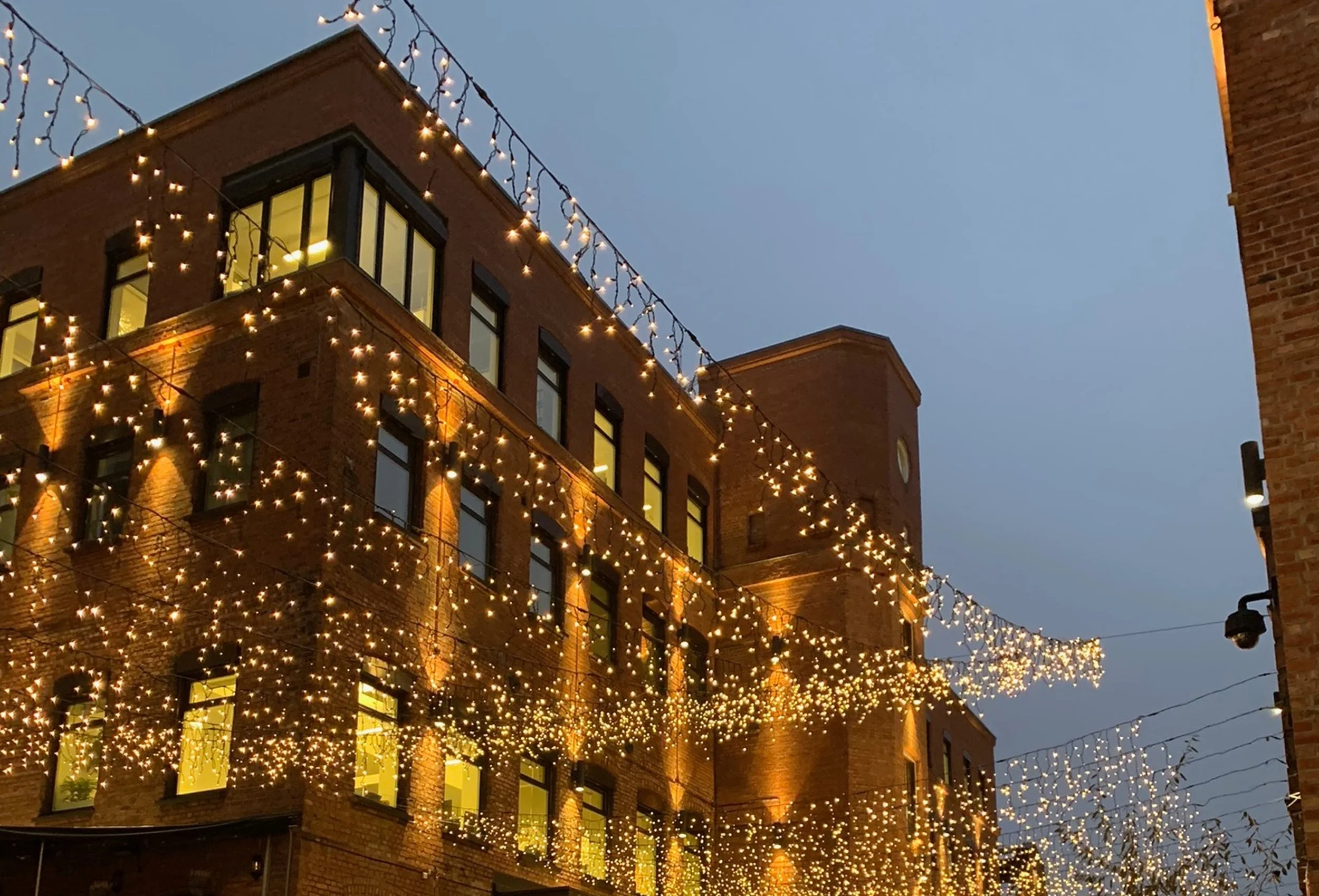 golden lights against brick buildings at dusk