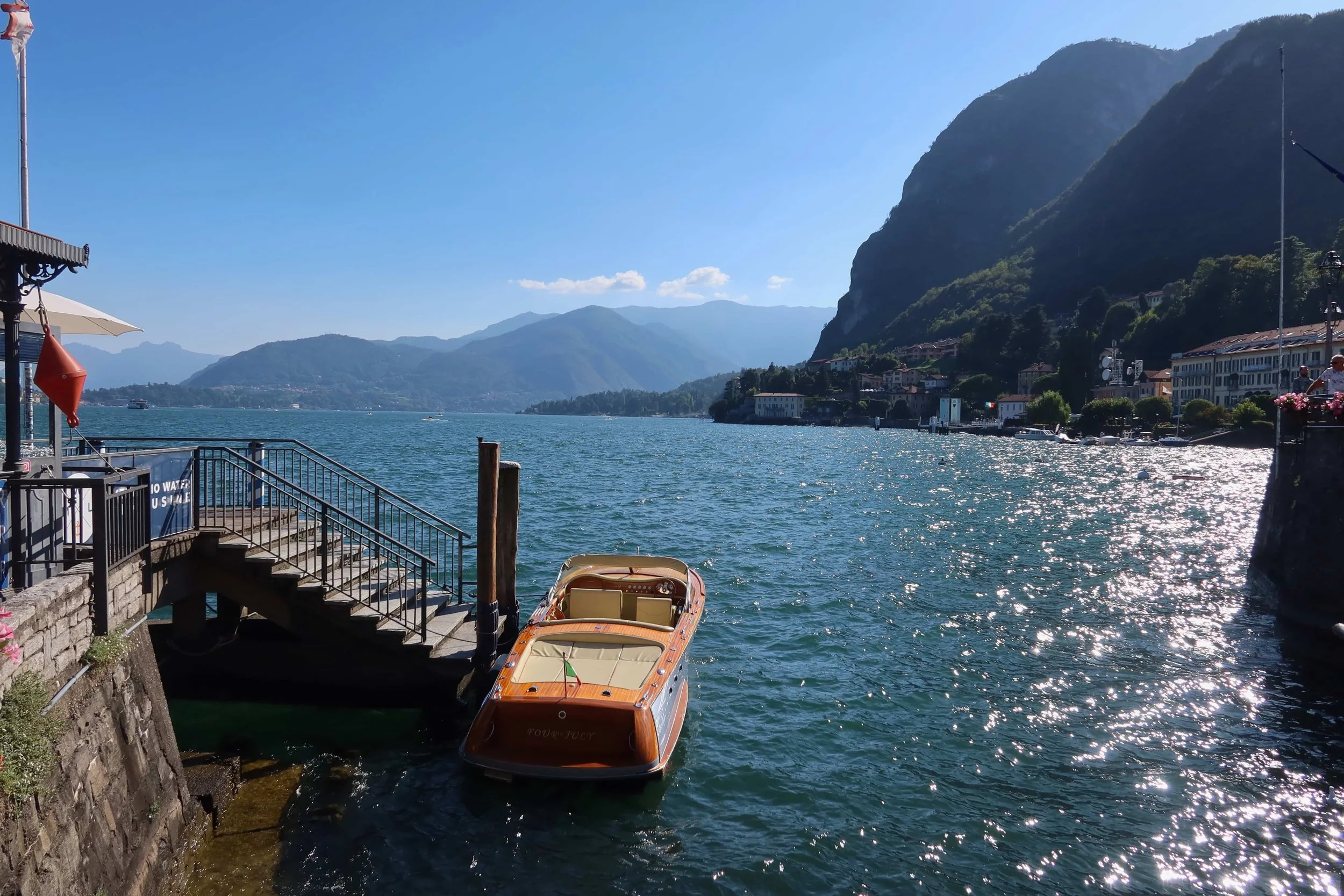 orange boat quiet menaggio sparkly water